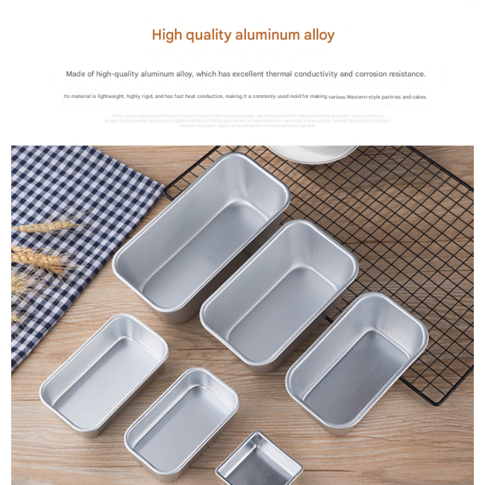 Mehrere Aluminium-Backformen in verschiedenen Größen liegen auf einem Holztisch.