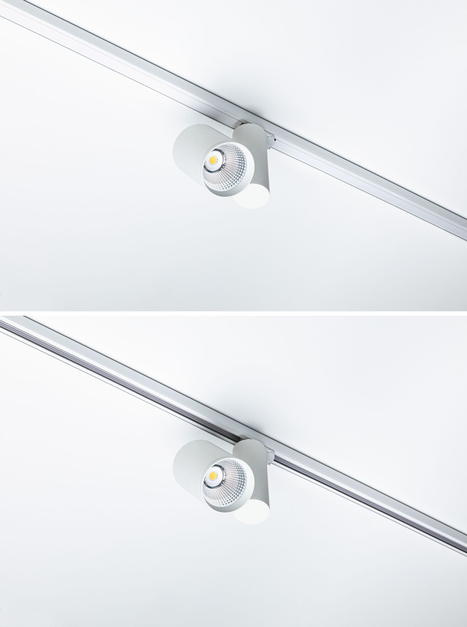 Zwei weiße Schienenstrahler mit LED-Licht auf einer weißen Decke.