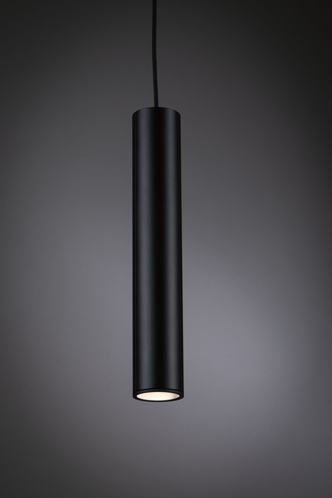 Czarna cylindryczna lampa wisząca z podświetleniem od dołu.