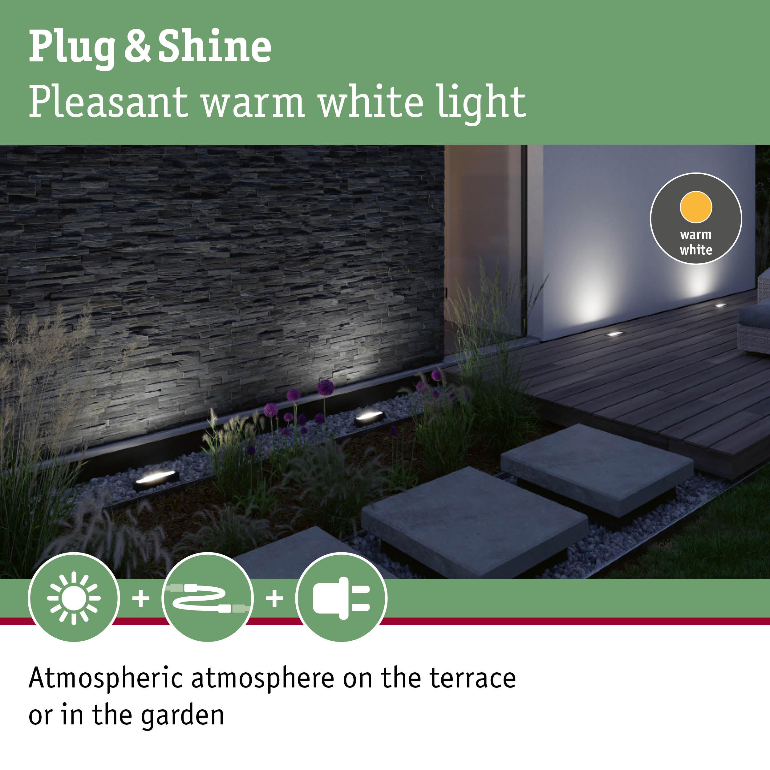 Gartenbeleuchtung mit warmweißem Licht auf einer Terrasse mit Steinwand.