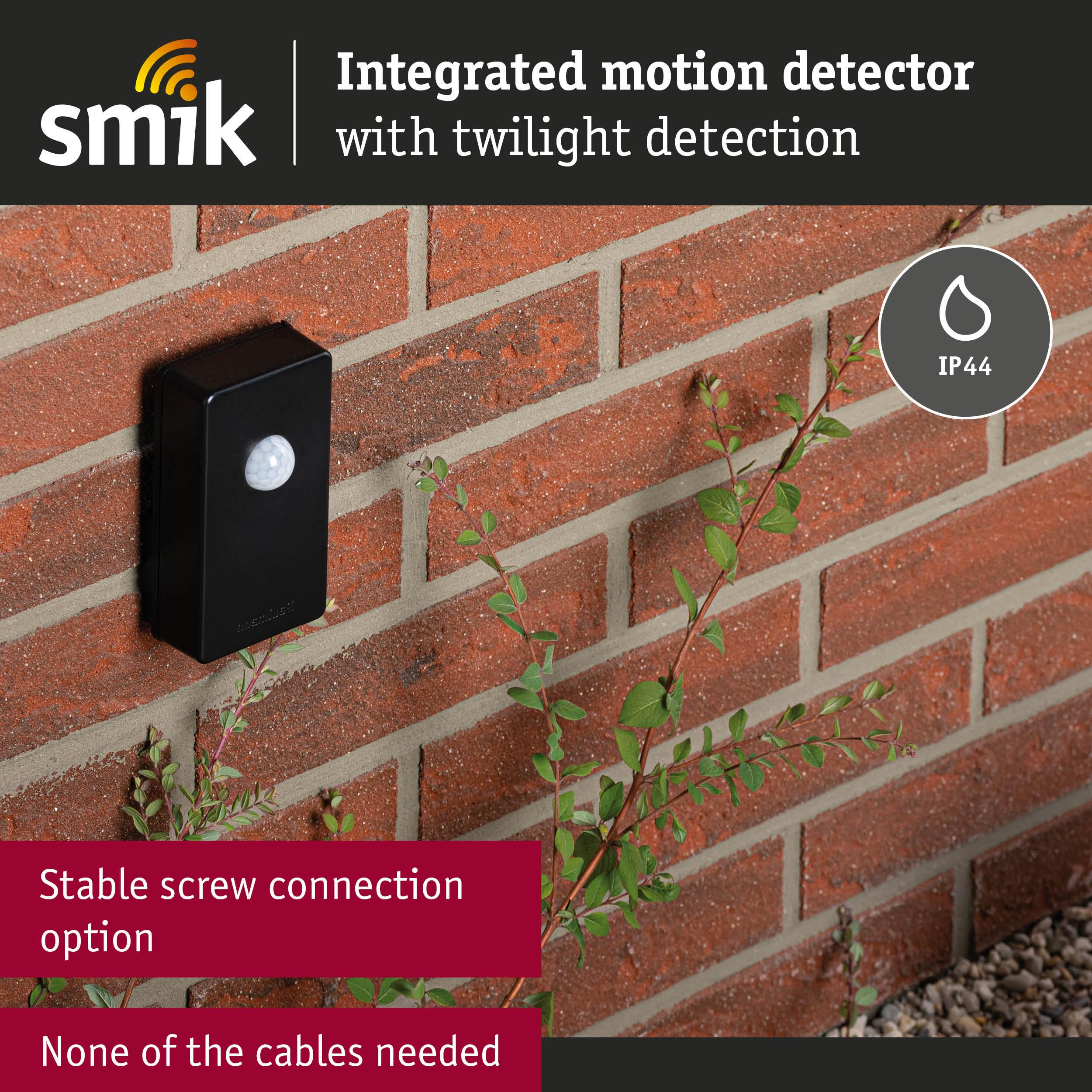 Czarny czujnik ruchu na ceglanej ścianie. IP44.