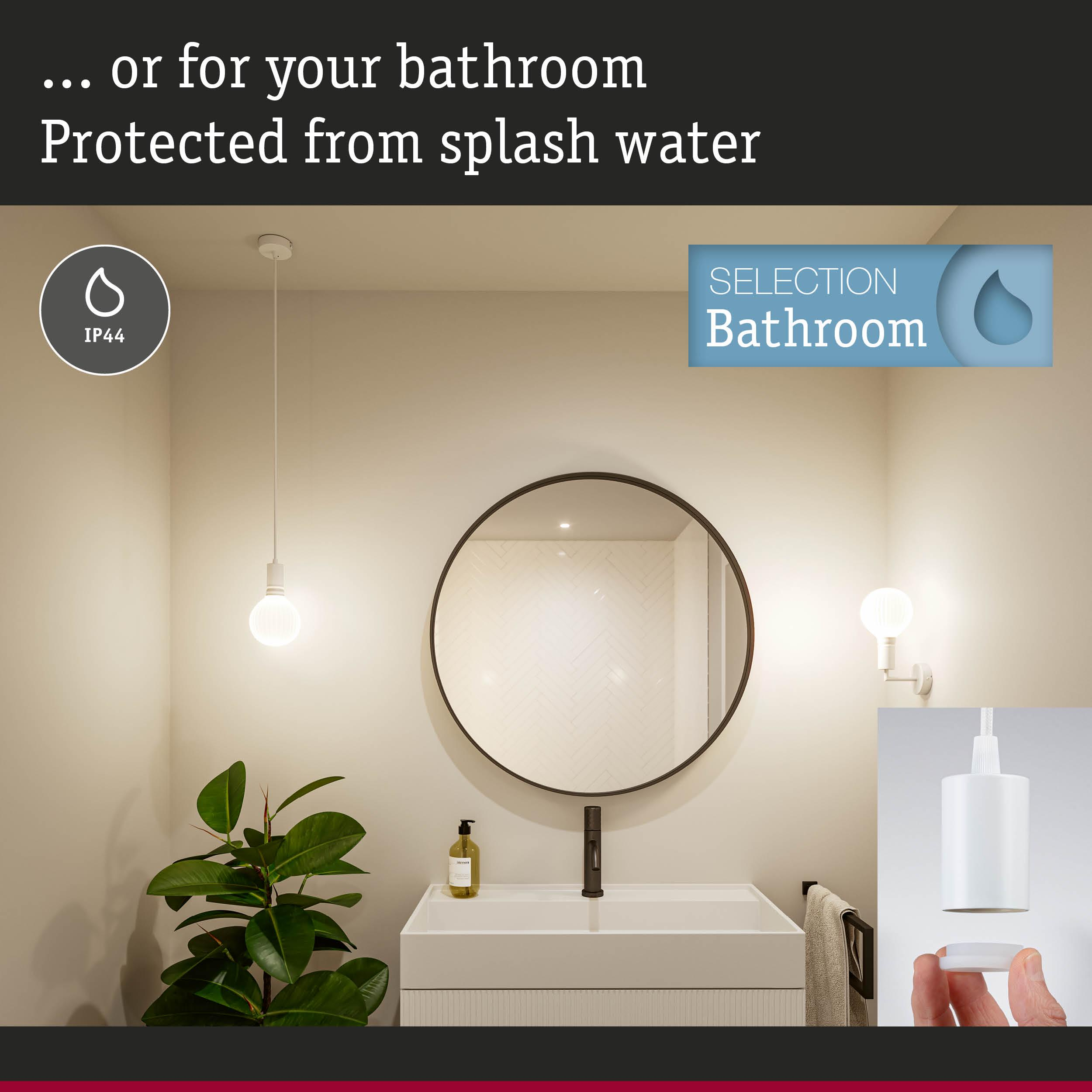 Badezimmer mit Waschbecken, Spiegel, Lampe und Pflanze. IP44-Schutz.