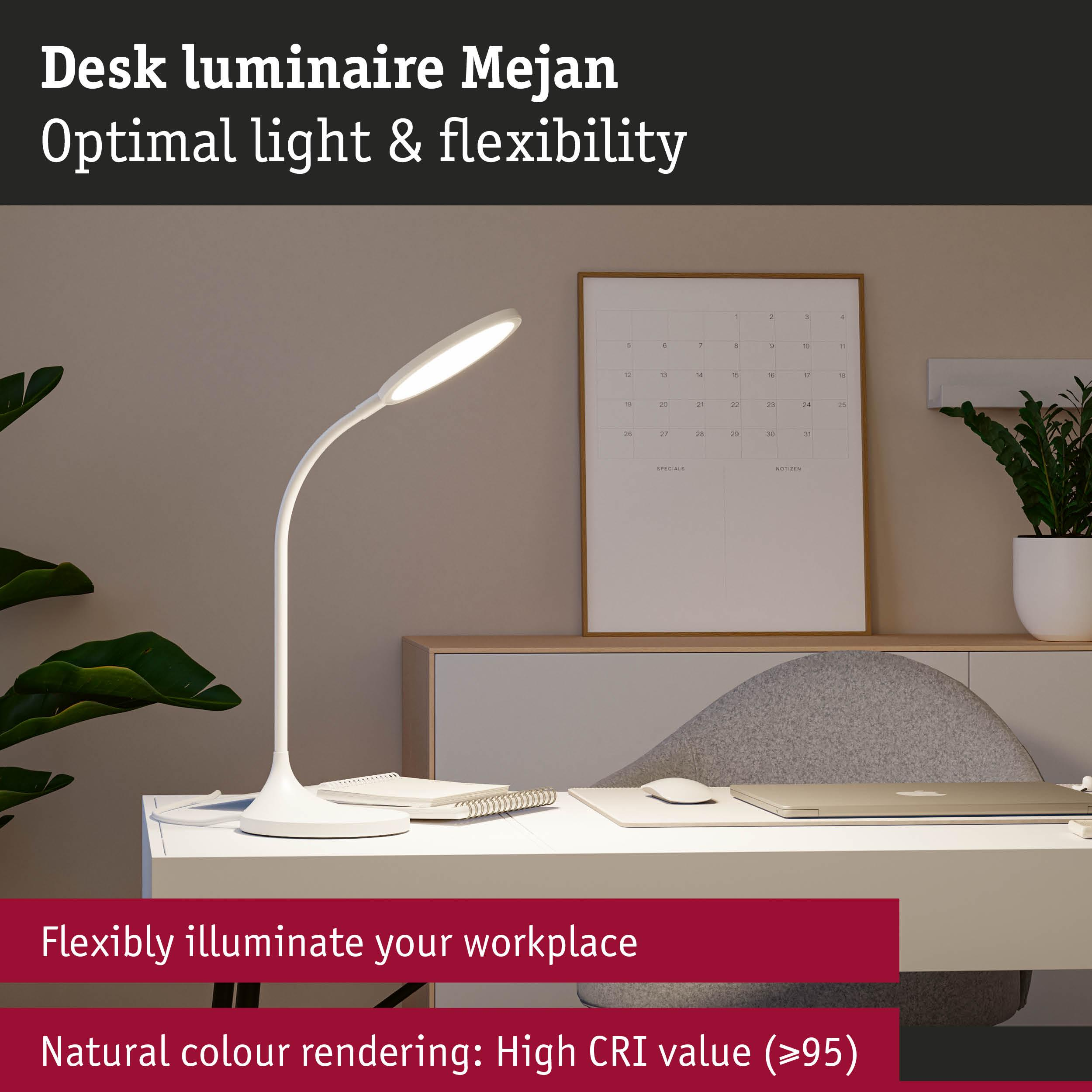 Biała lampa biurkowa oświetla miejsce pracy z kalendarzem i rośliną.