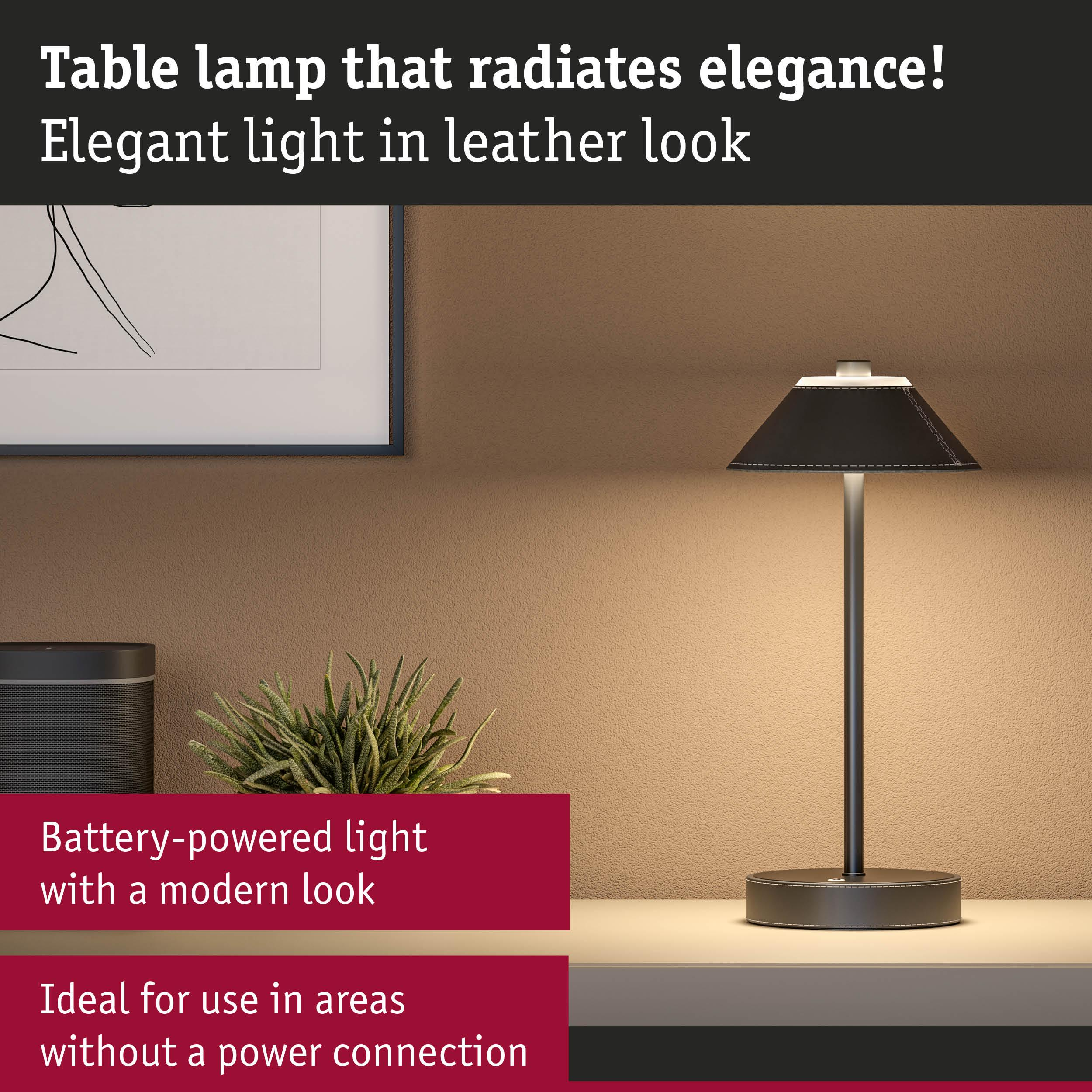 Elegancka czarna lampa stołowa imitująca skórę, podświetlona.