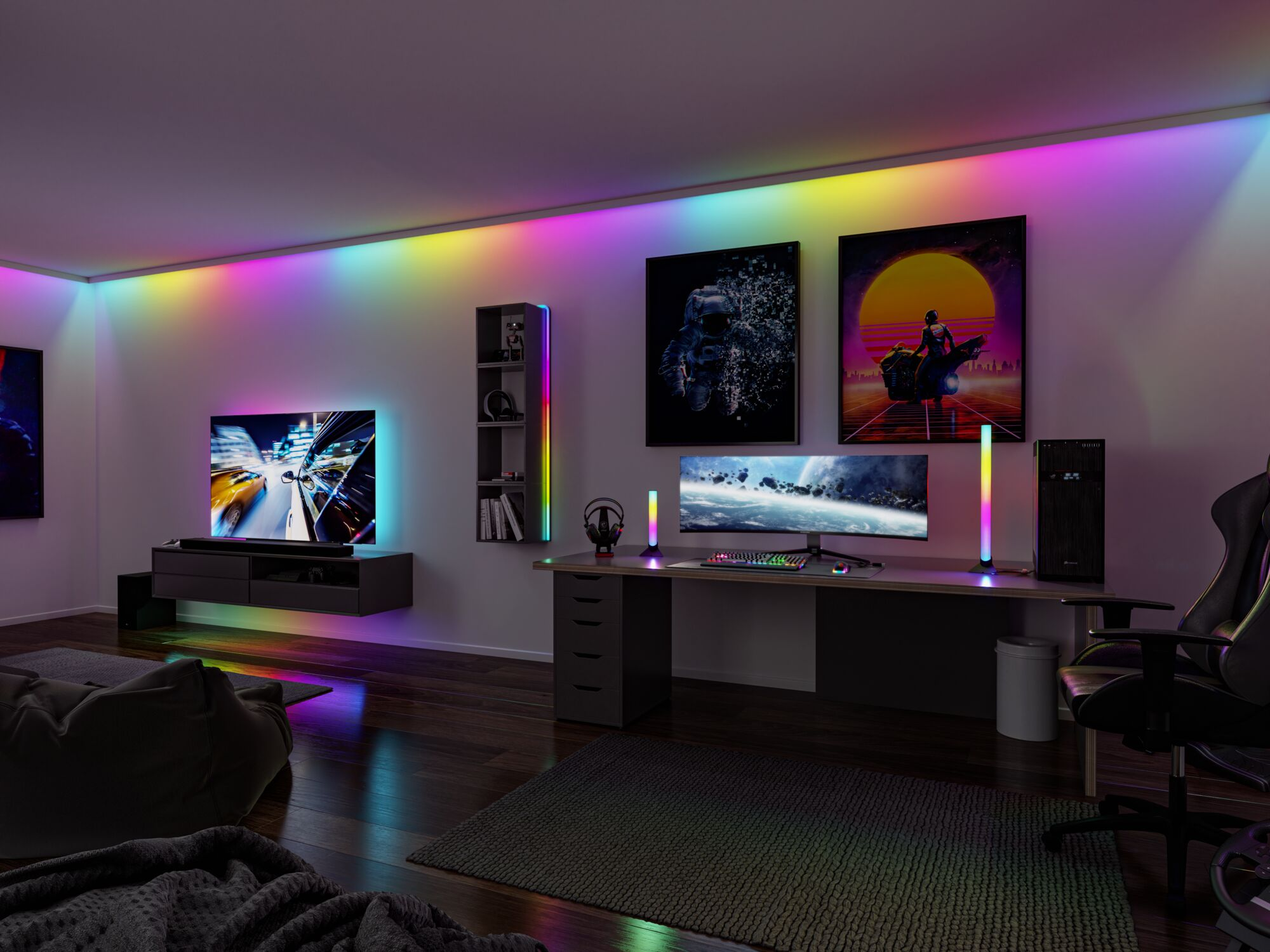 Una stanza da gaming con illuminazione RGB, scrivania, PC, monitor e arte.