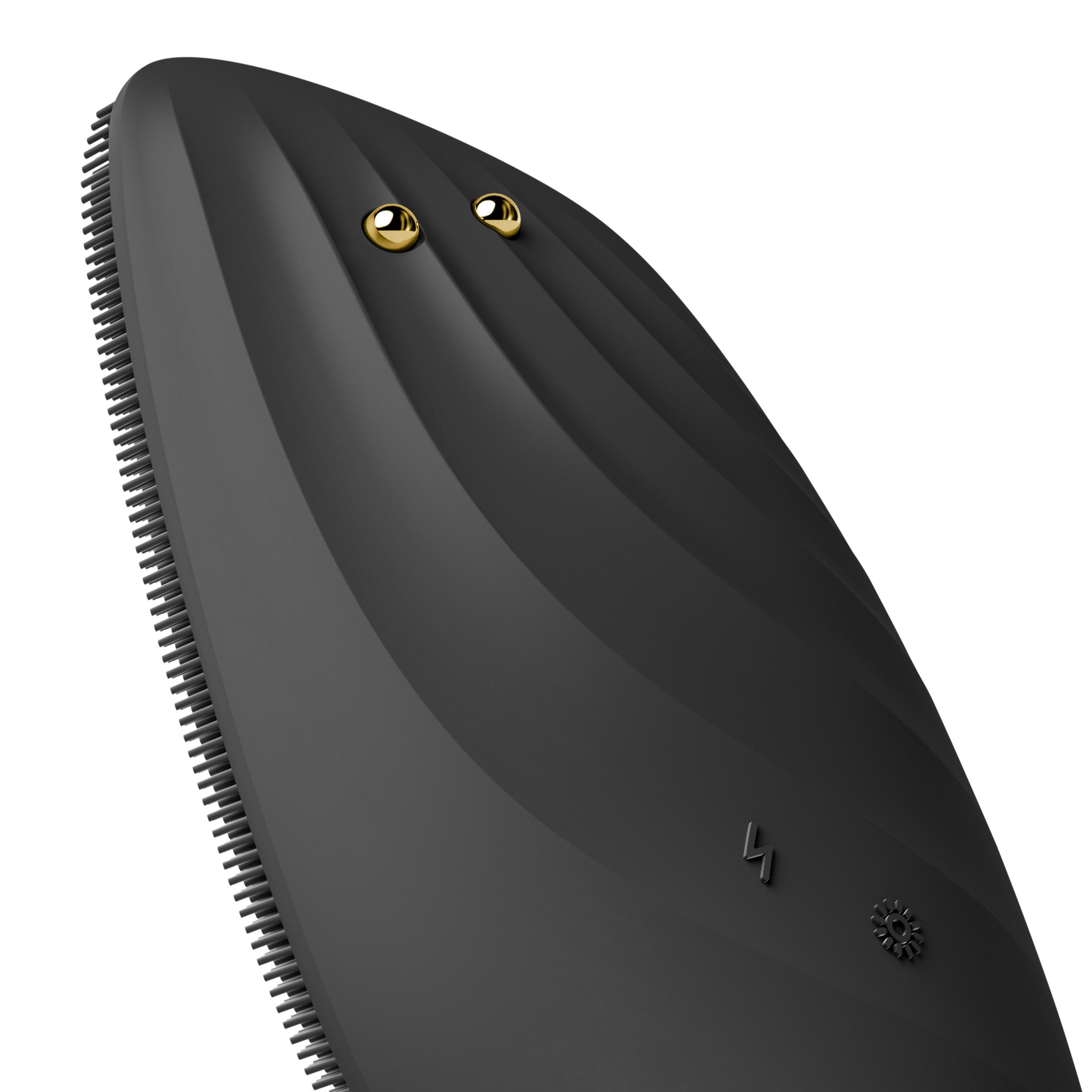 Un dispositivo ergonomico nero con due sfere dorate e bordo setolato.