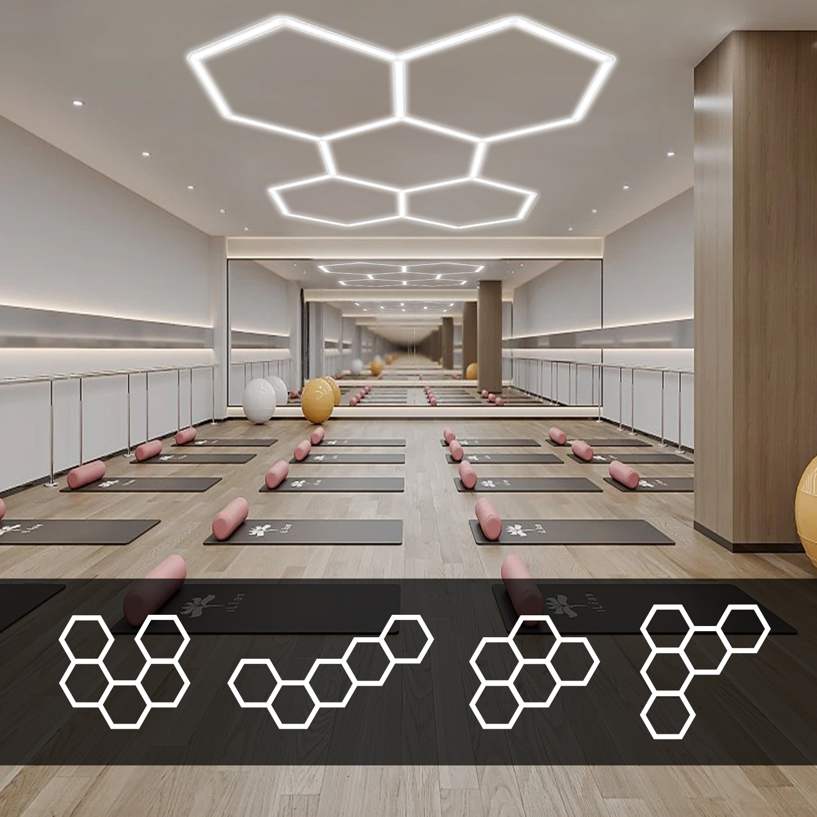 Un estudio de yoga luminoso con colchonetas, rodillos rosas, pelotas y luces de techo geométricas.