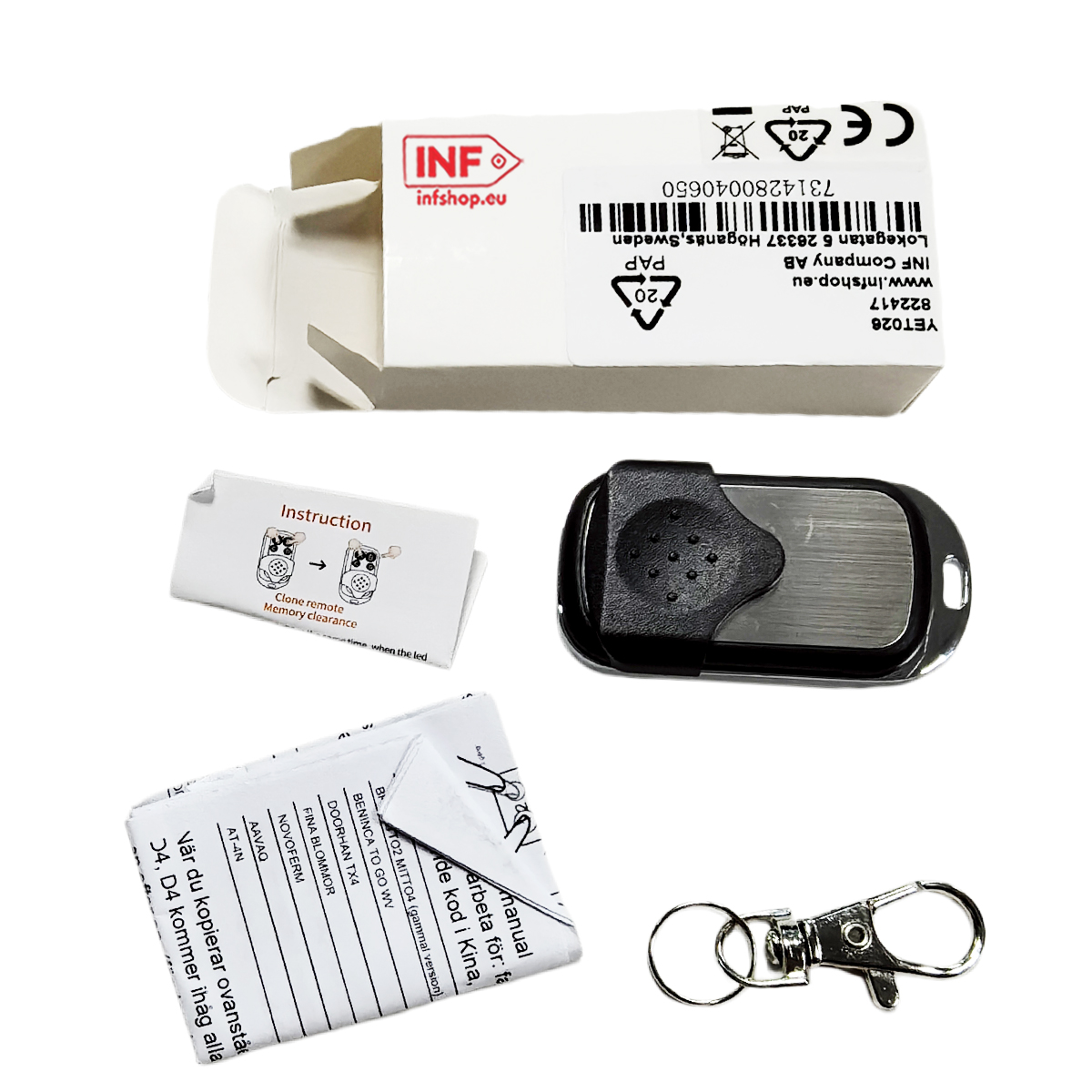 Otwieracz do bram garażowych, instrukcja i brelok na białym tle.