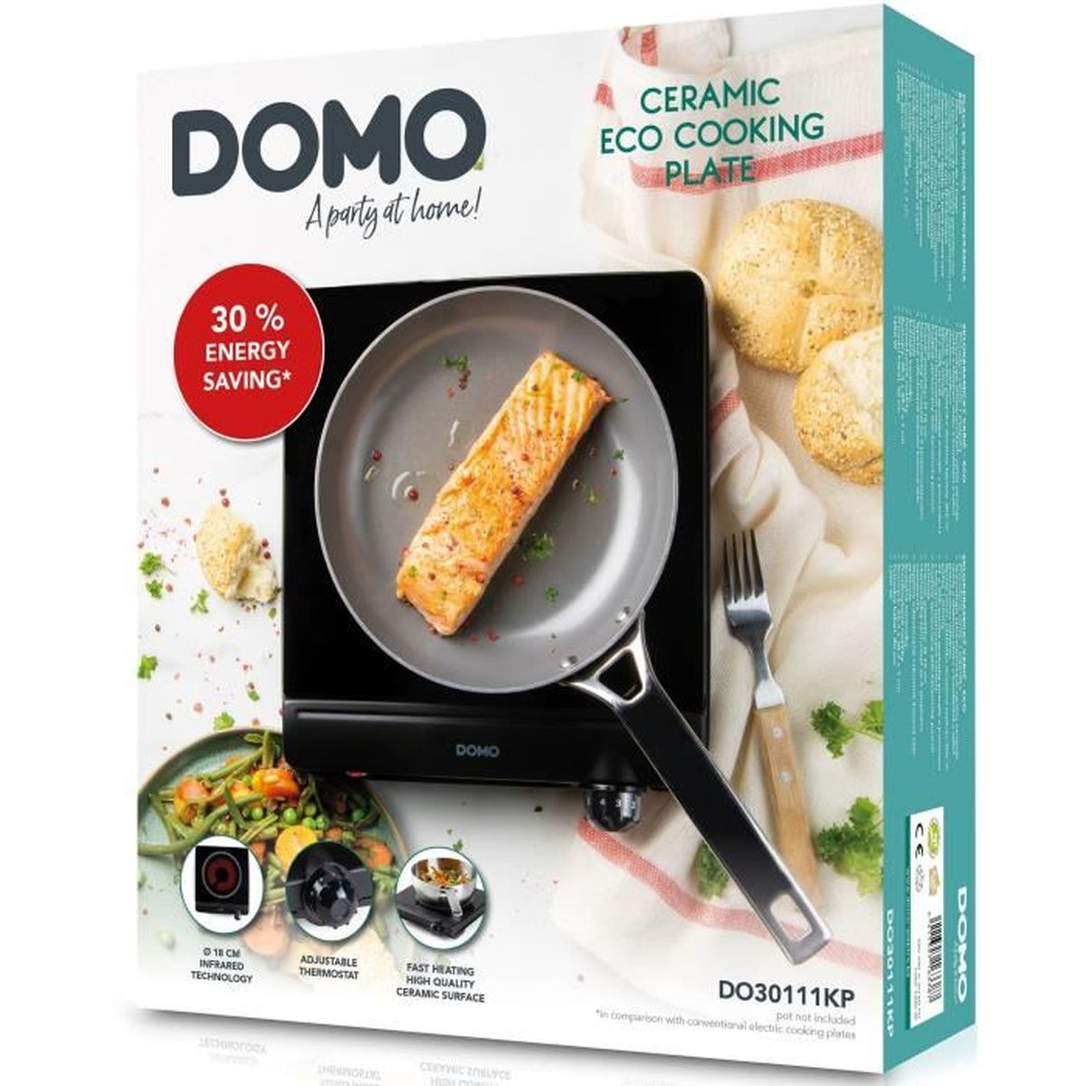 Plaque de cuisson DOMO avec saumon à la poêle, petits pains et fourchette.