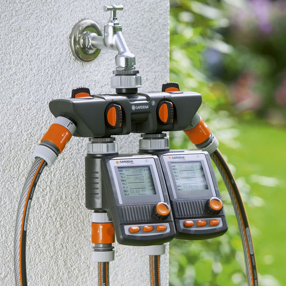 Gartenschlauchverteiler mit zwei digitalen Timern an einem Wasserhahn.