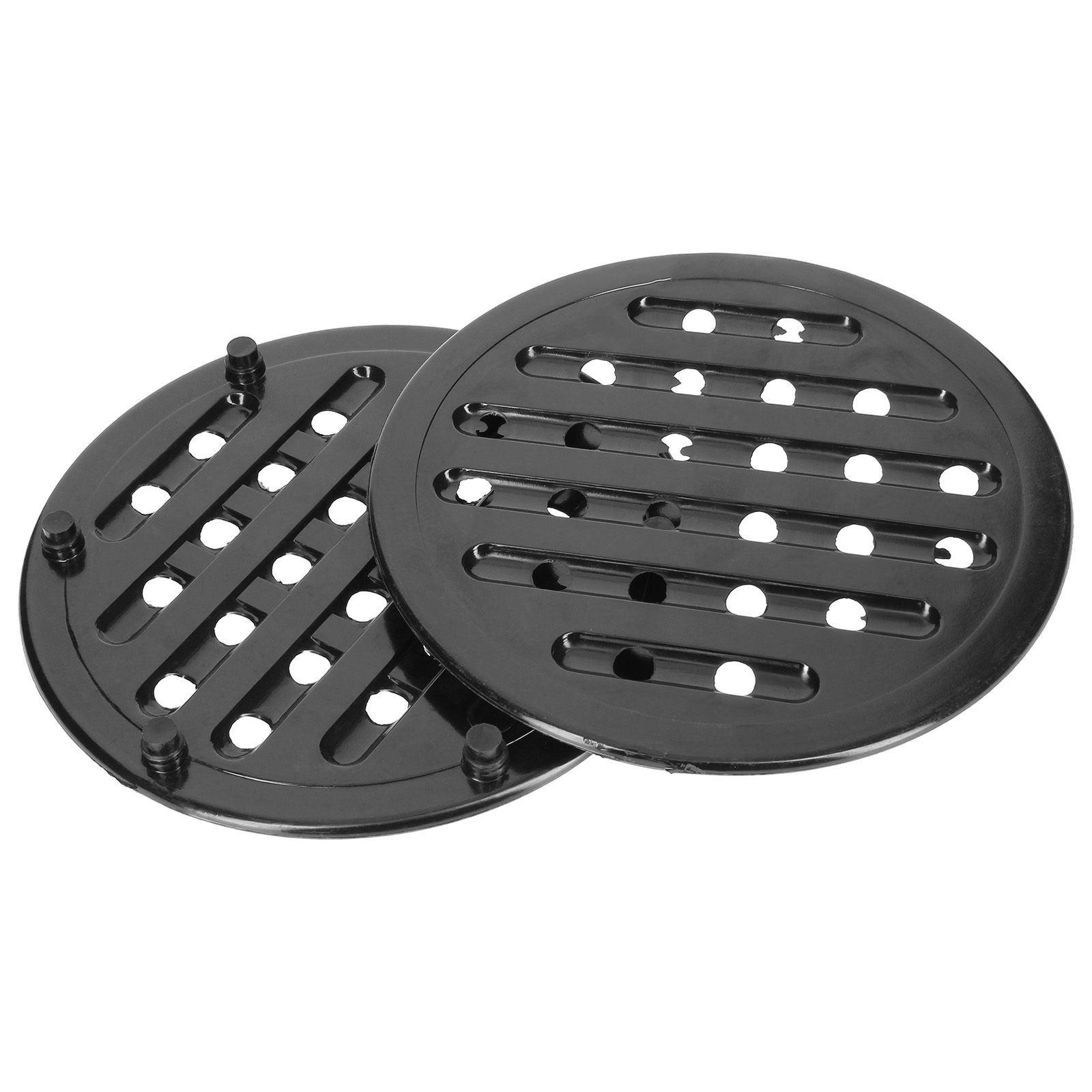 Dos cubiertas de drenaje negras redondas con ranuras y agujeros.