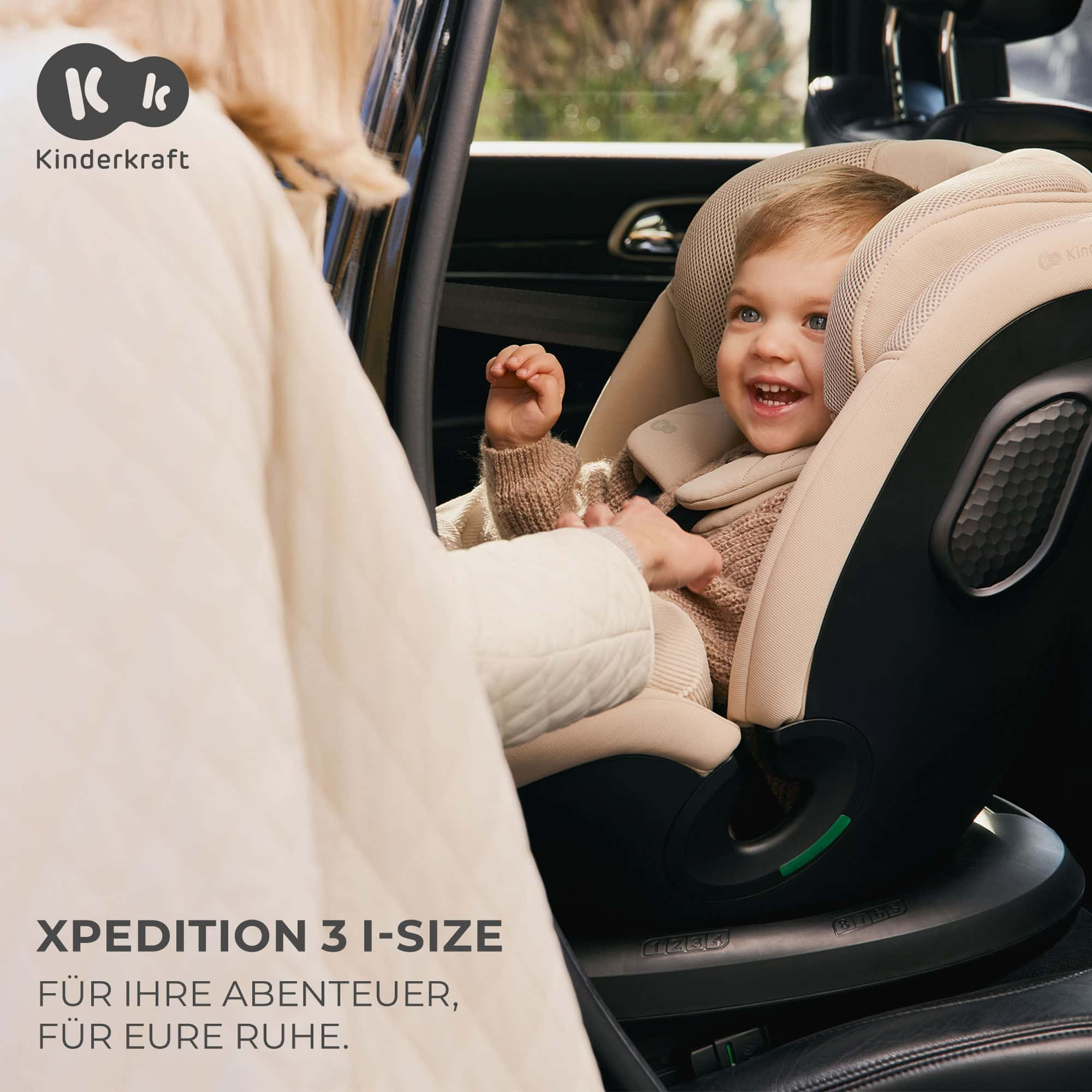 Ein lächelndes Baby sitzt in einem Kinderkraft Kindersitz im Auto.