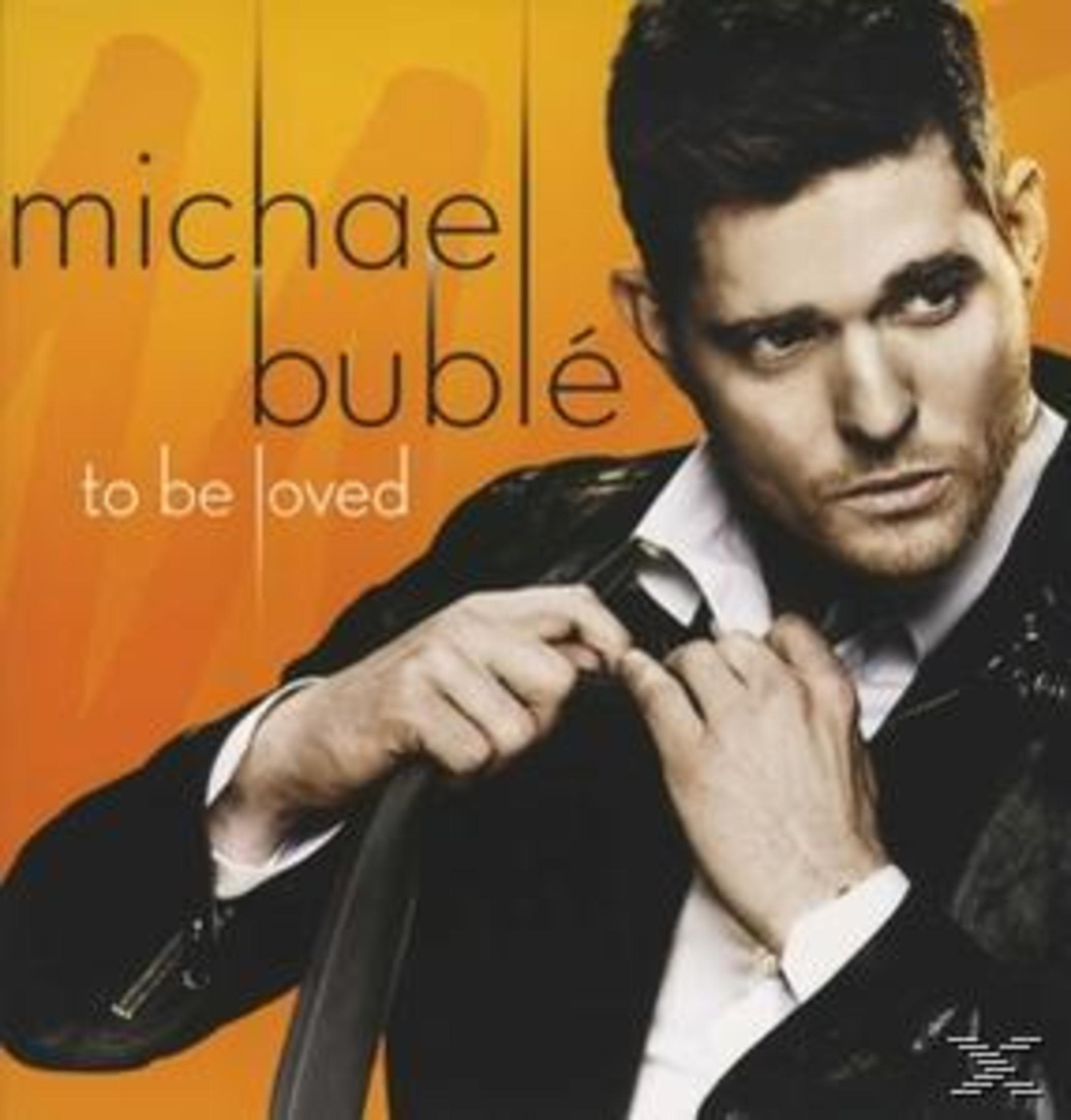 Michael Bublé con titolo album 'To Be Loved' su sfondo arancione.