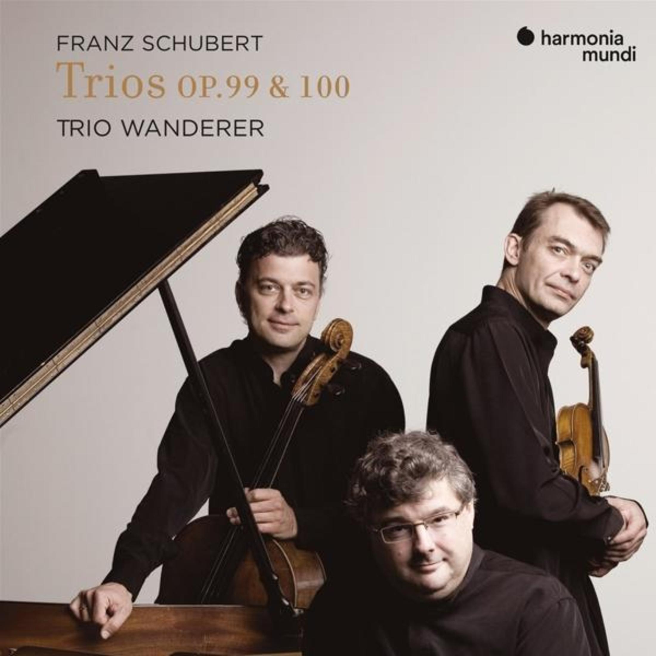 Tre uomini con strumenti davanti a un pianoforte. Trii di Franz Schubert eseguiti dal Trio Wanderer.