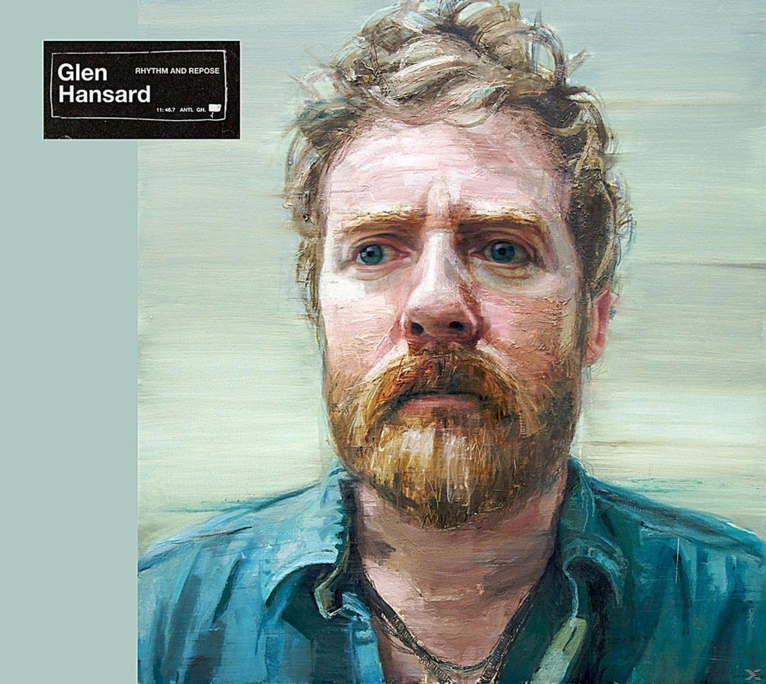 Dipinto di un uomo barbuto con una camicia blu. 'Glen Hansard' è scritto in alto a sinistra.