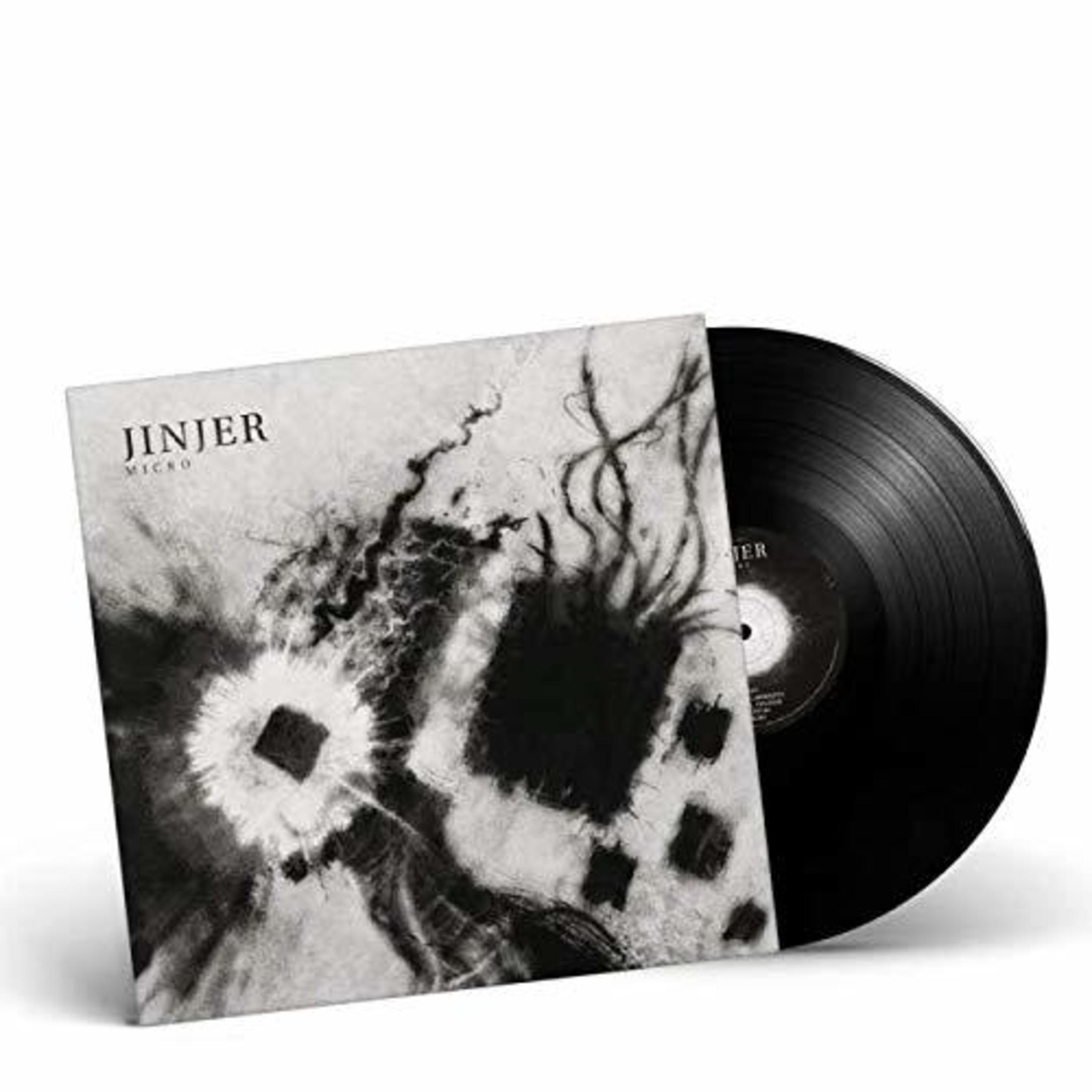 Un disco in vinile nero con la copertina dell'album "Jinjer Micro" accanto, su sfondo bianco.