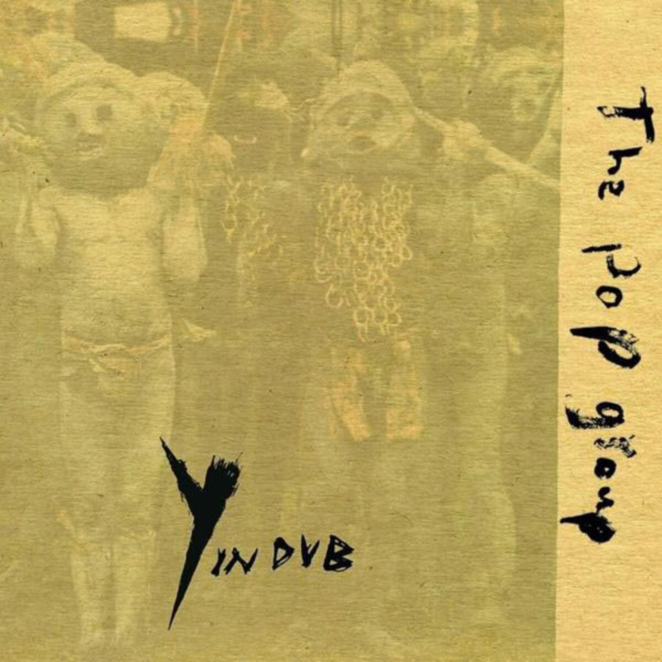 Un gruppo di figure con catene, accanto al testo 'The Pop Group' e 'Y IN DVB'.