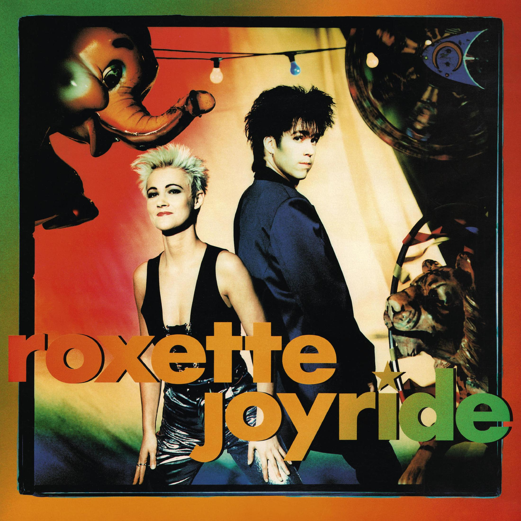 Copertina album Roxette Joyride con duo, elefante, leone e luci.