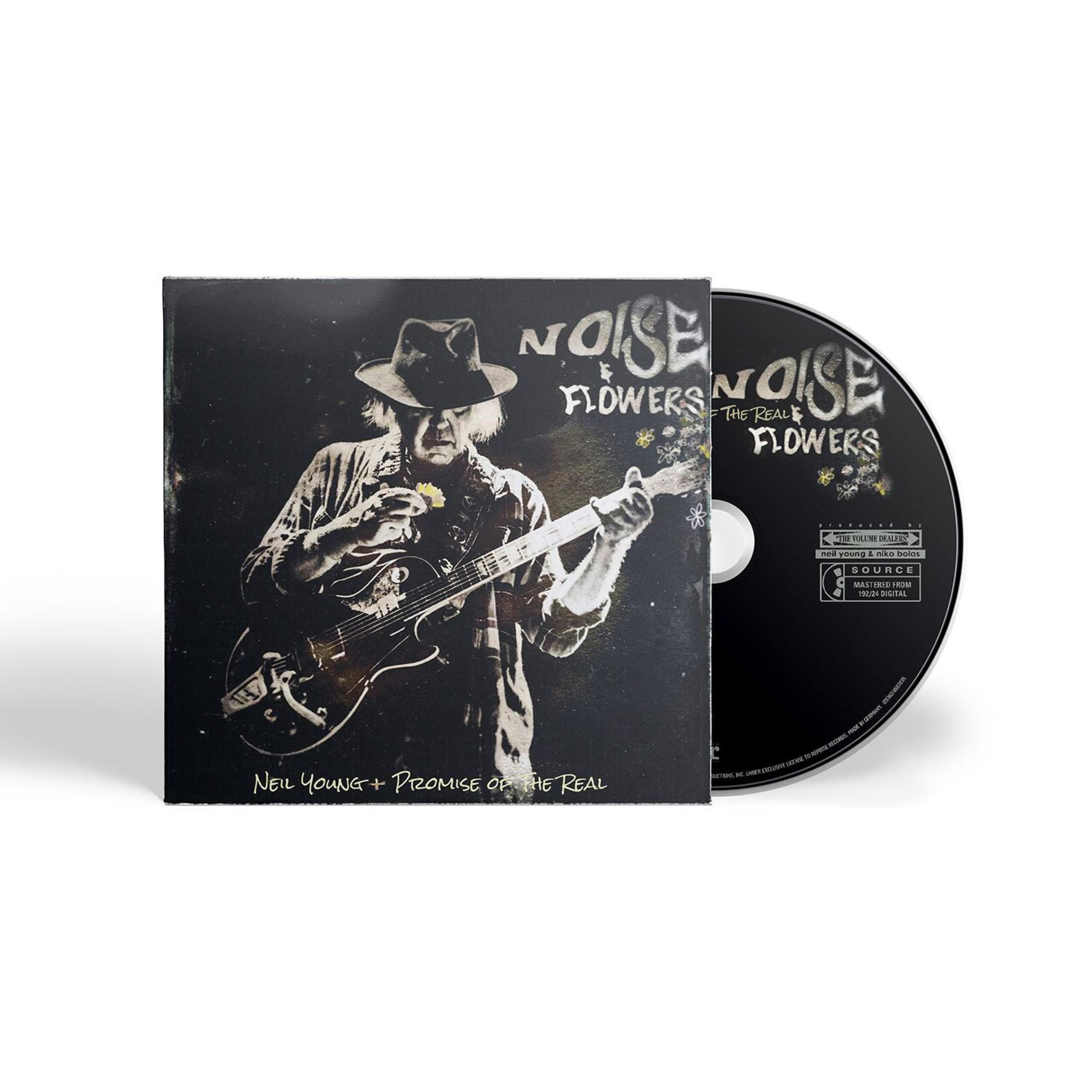 Neil Young suona la chitarra, accanto un CD intitolato 'Noise Flowers'.