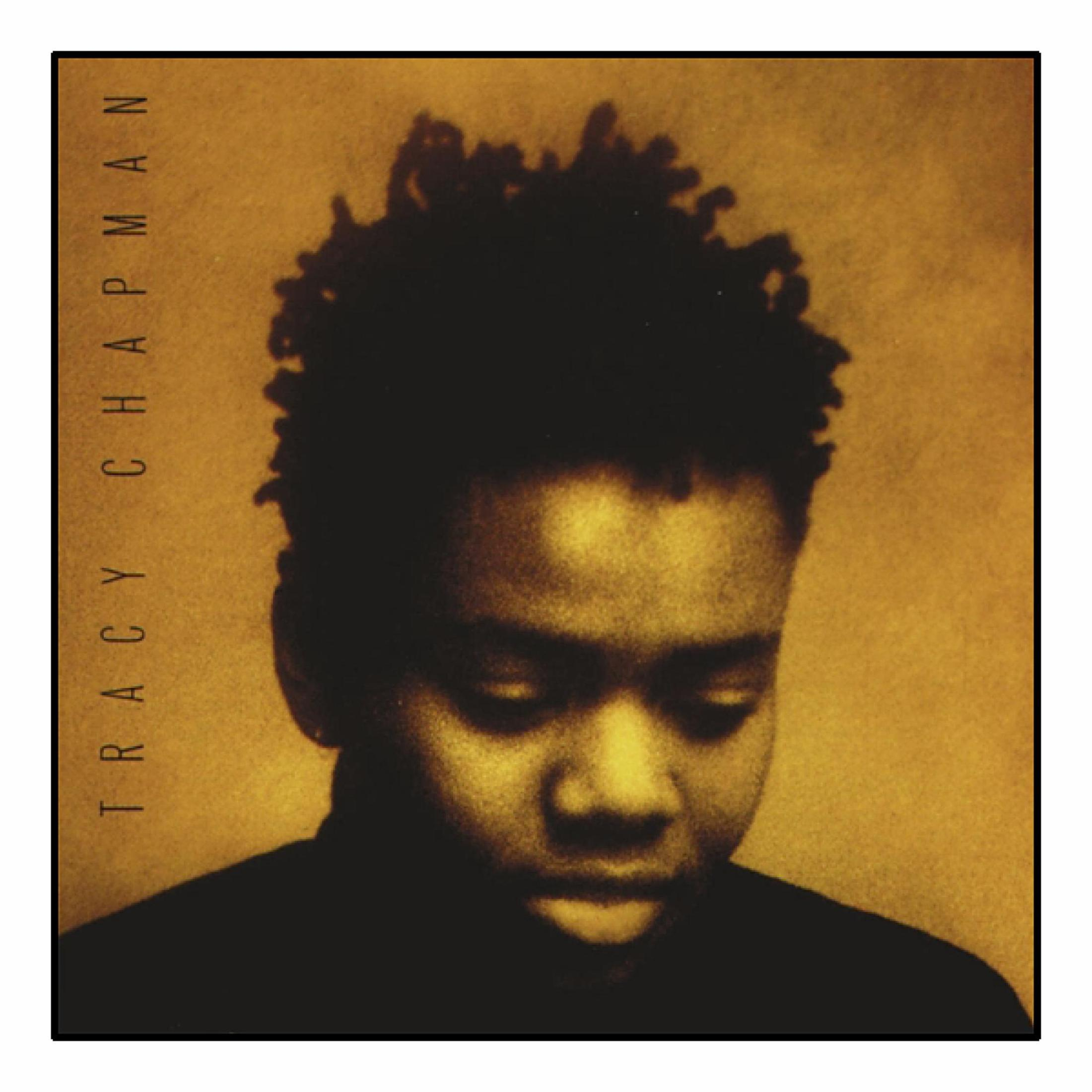 Ritratto di Tracy Chapman con capelli ricci, che guarda in basso. Sfondo giallo.