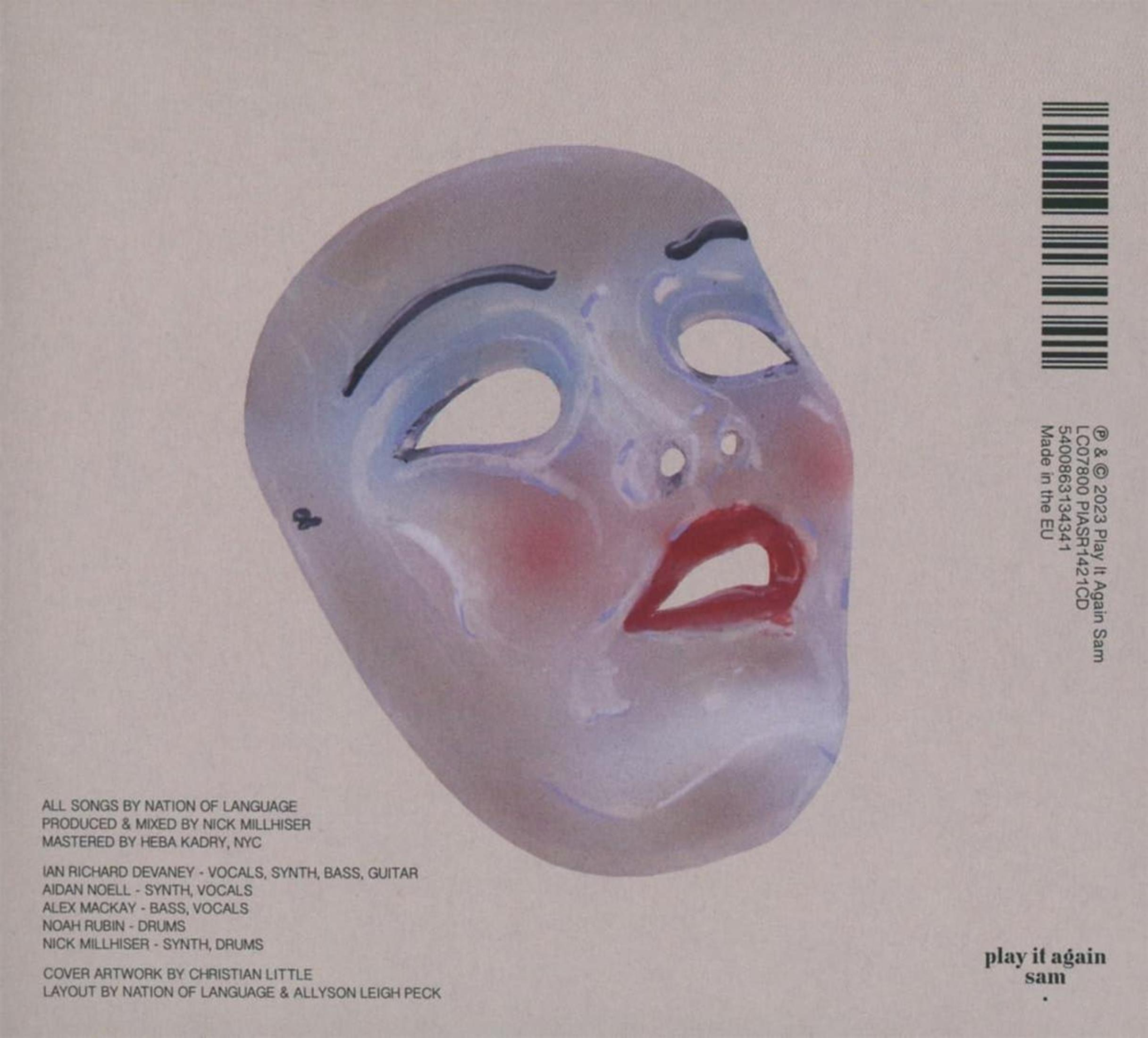 Una maschera blu con guance e labbra rosse su sfondo grigio chiaro.