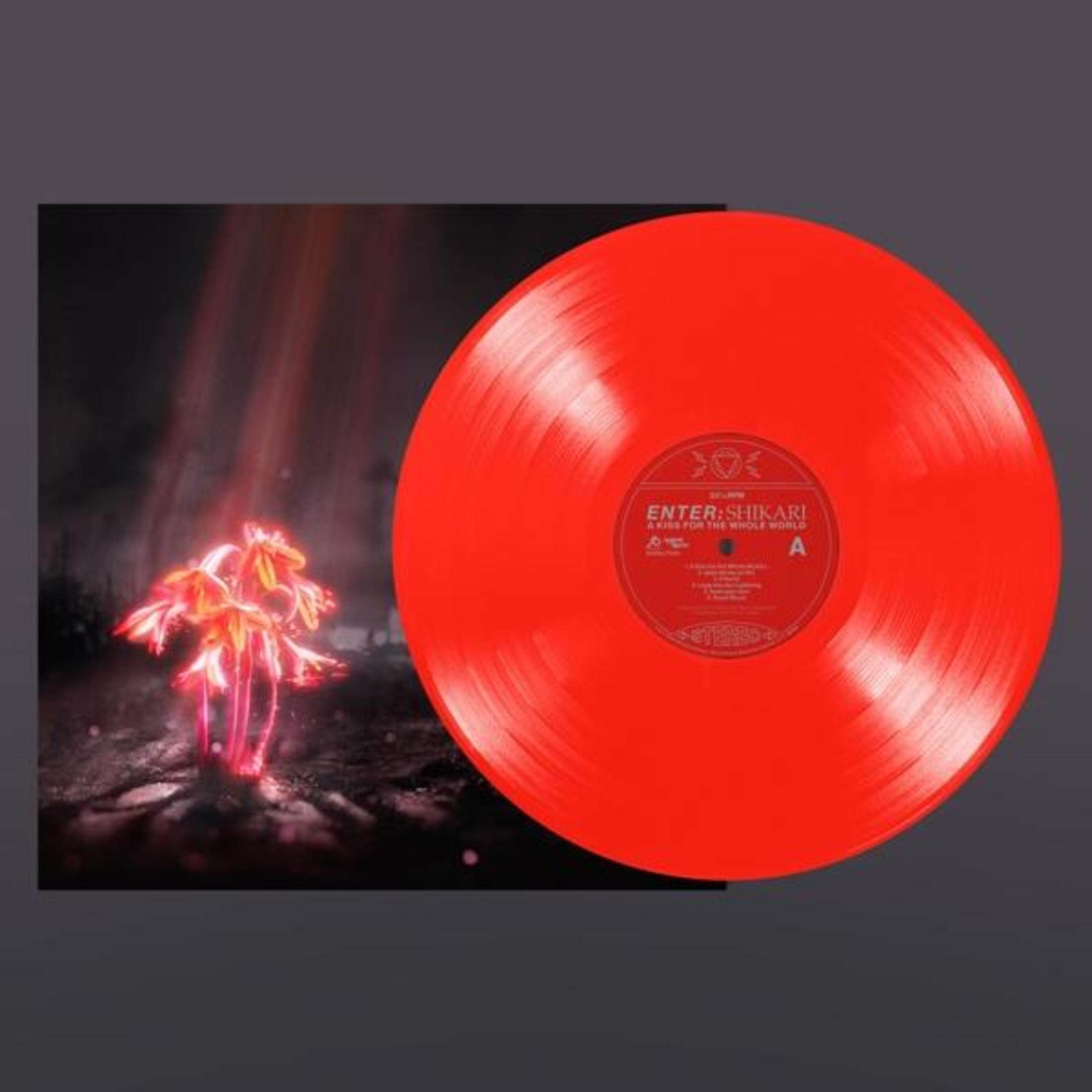 Disco in vinile rosso accanto alla copertina con piante luminose.