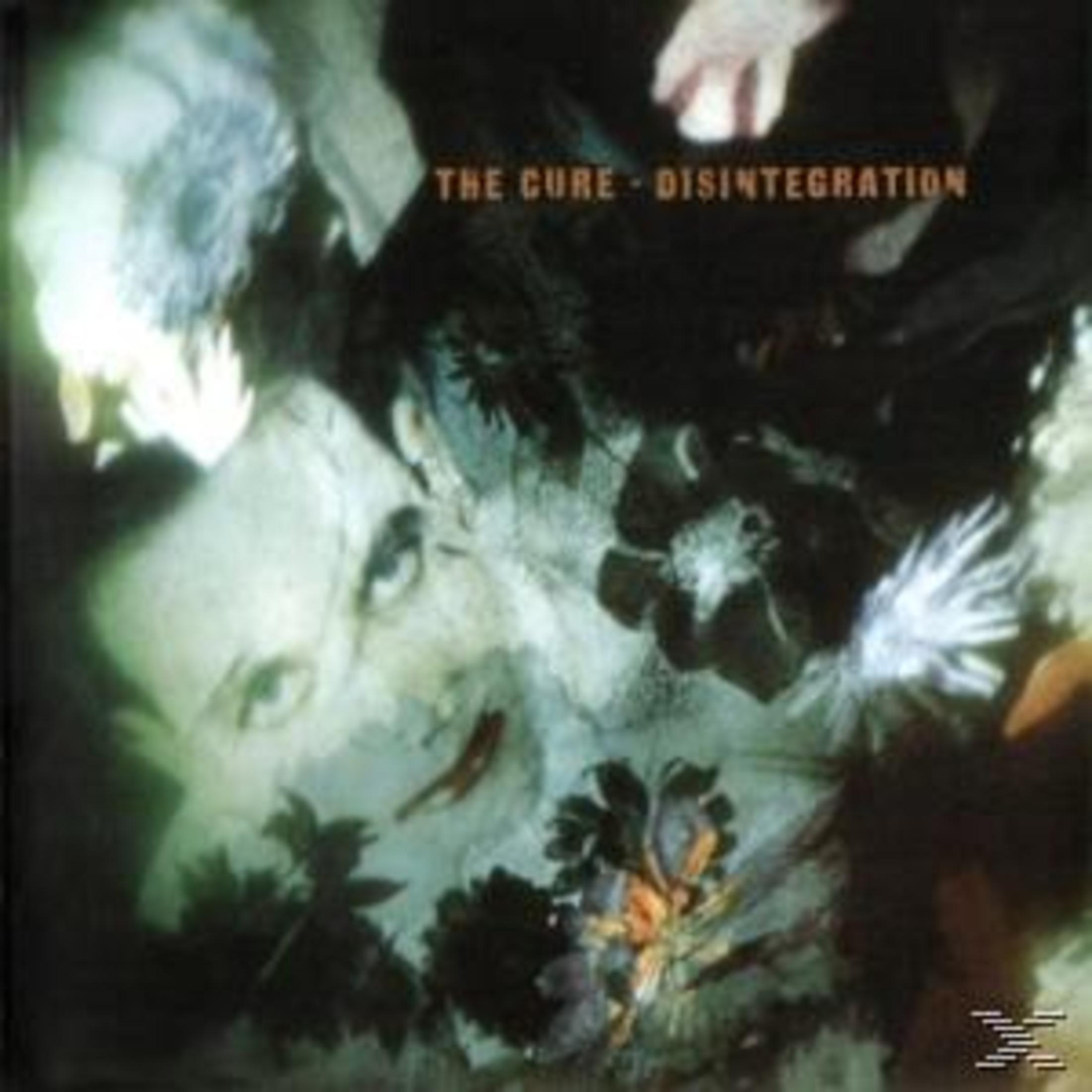 Copertina album The Cure - Disintegration. Un volto pallido emerge da fiori e fogliame scuri.