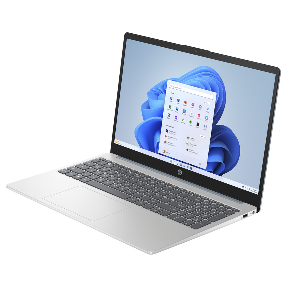 Srebrny laptop z otwartym ekranem, wyświetlający system Windows 11 i listę aplikacji.