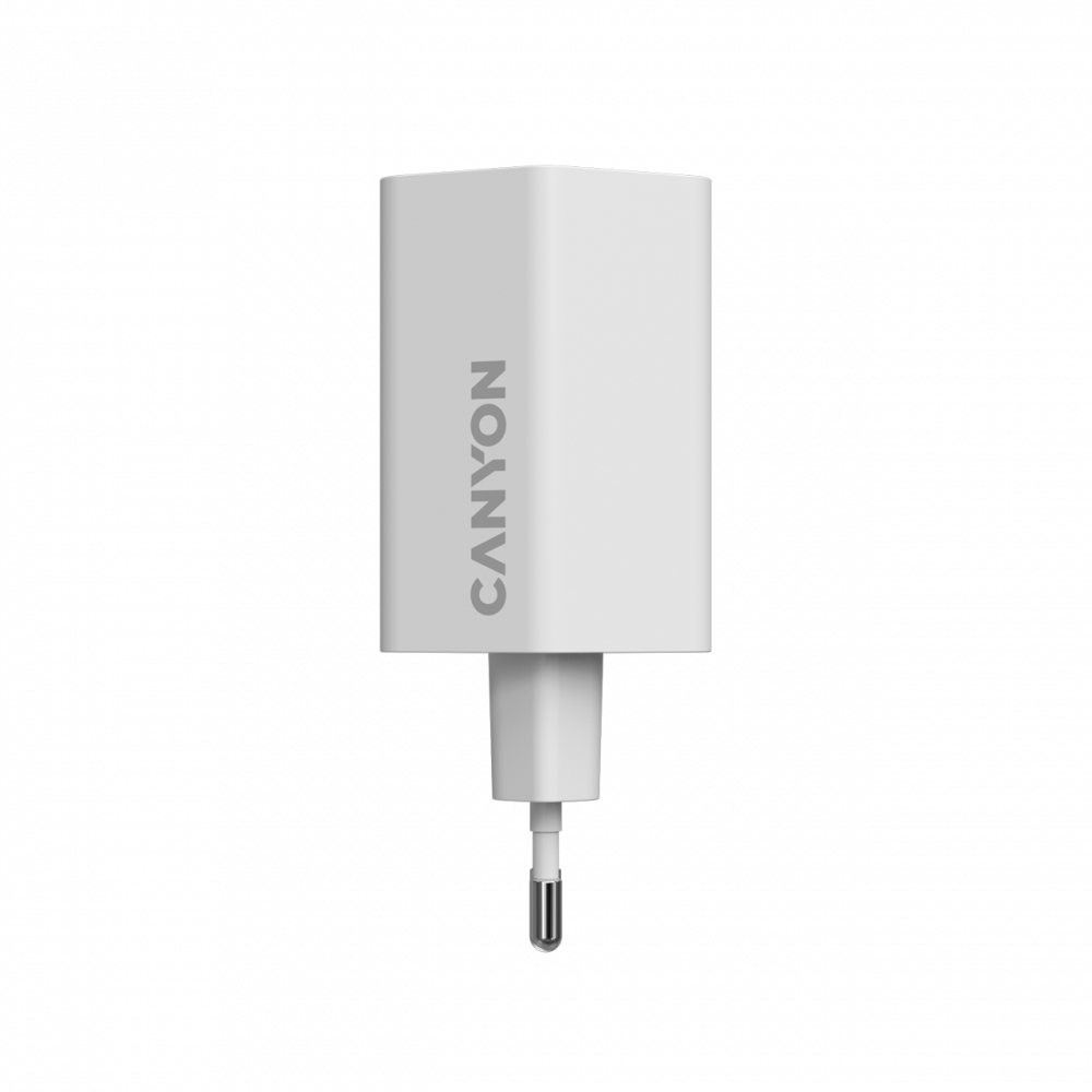 Biały adapter zasilający Canyon z srebrnym logo na czarnym tle.