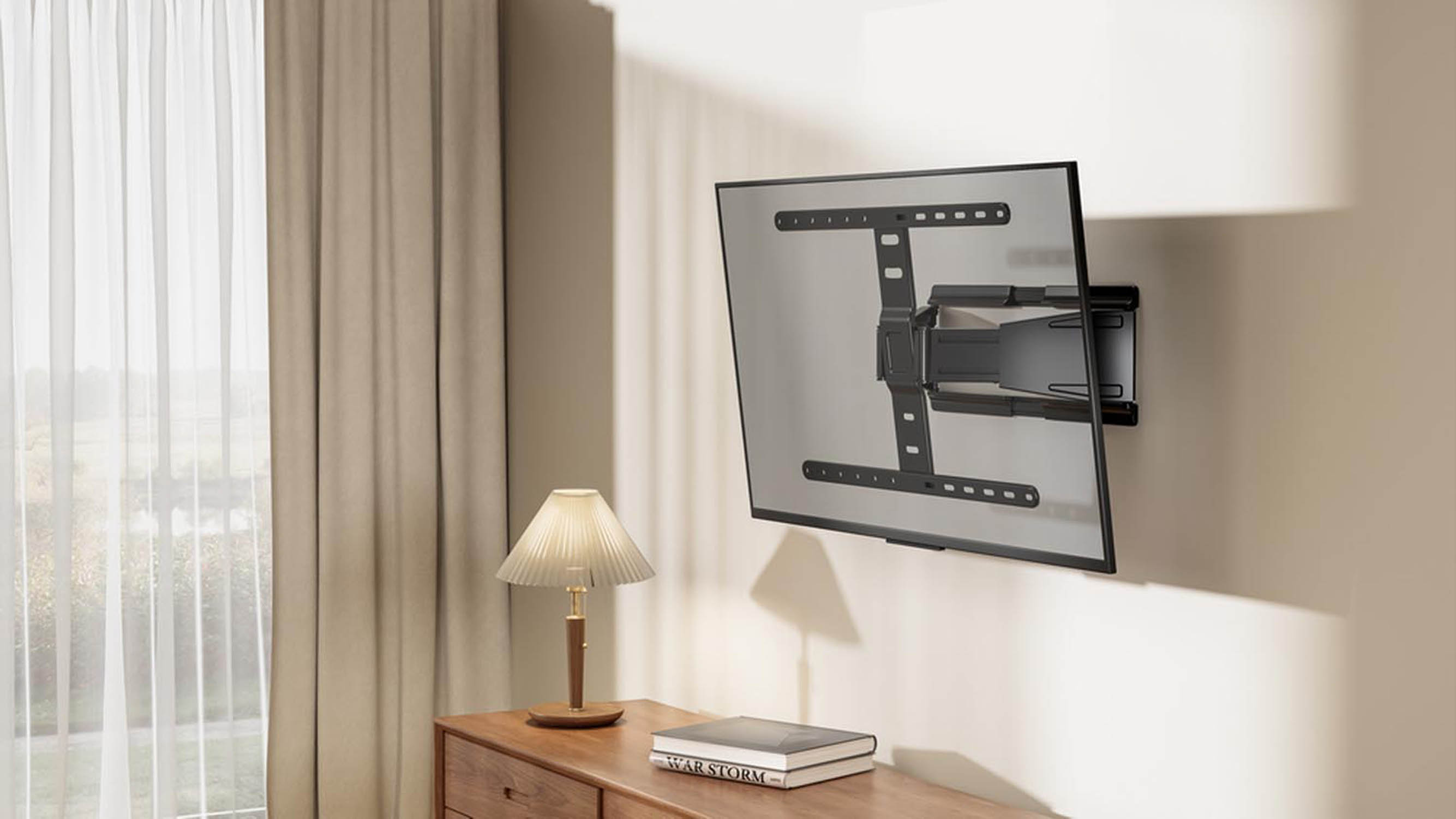 A modern TV is mounted on a wall bracket. Curtains and a lamp are nearby.
