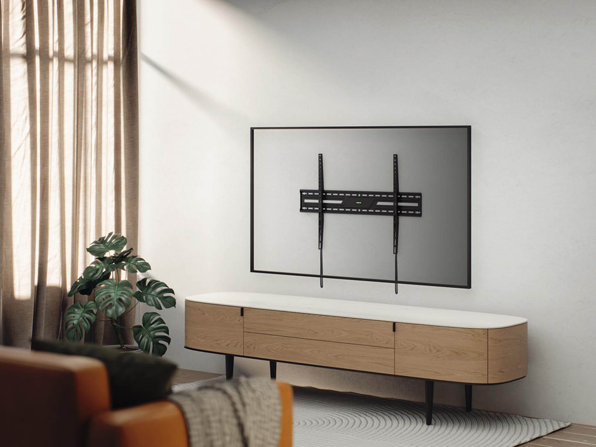 Un coin salon moderne avec une télévision murale au-dessus d'une armoire en bois.