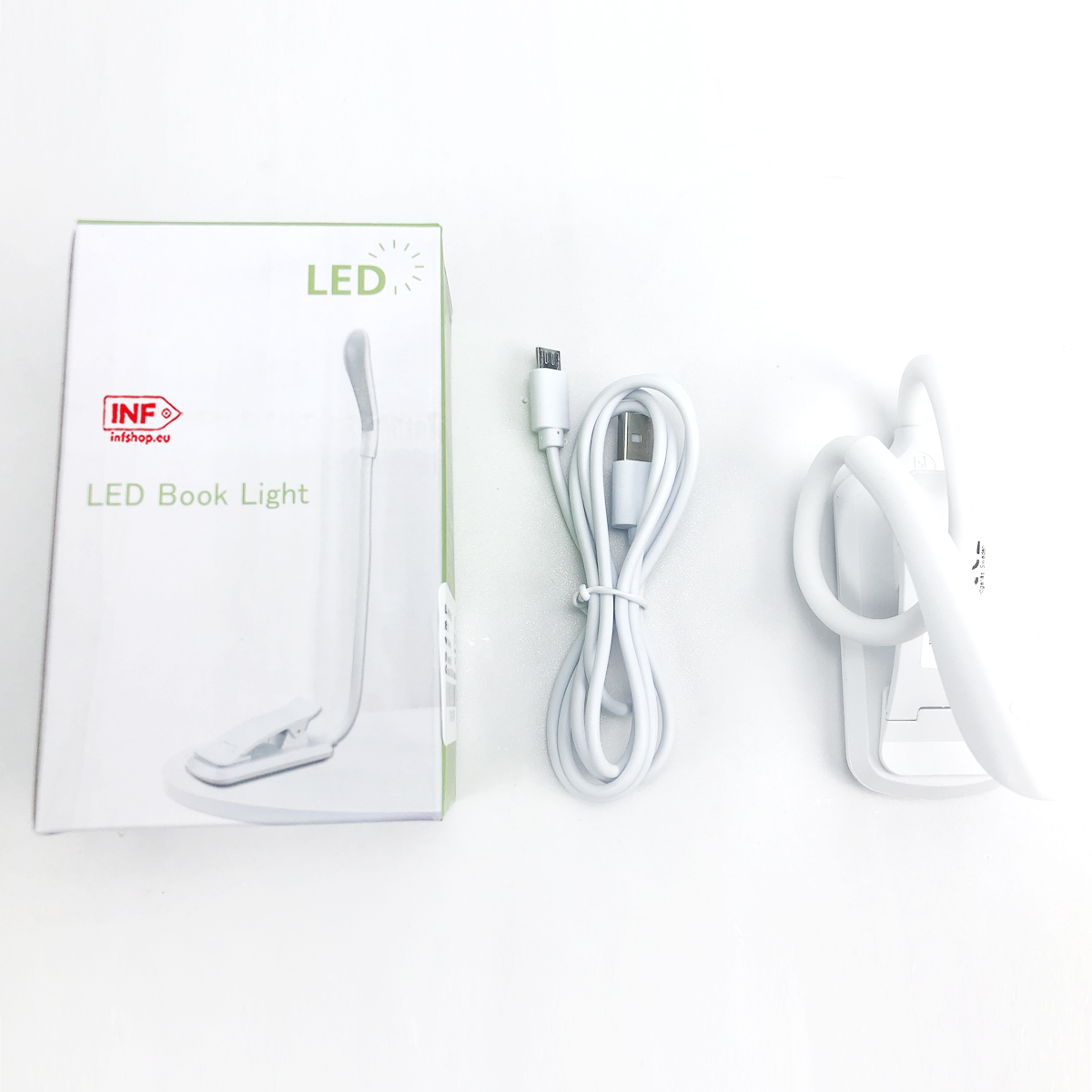 Witte LED-boekenlamp met clipvoet, USB-kabel en klemgedeelte.