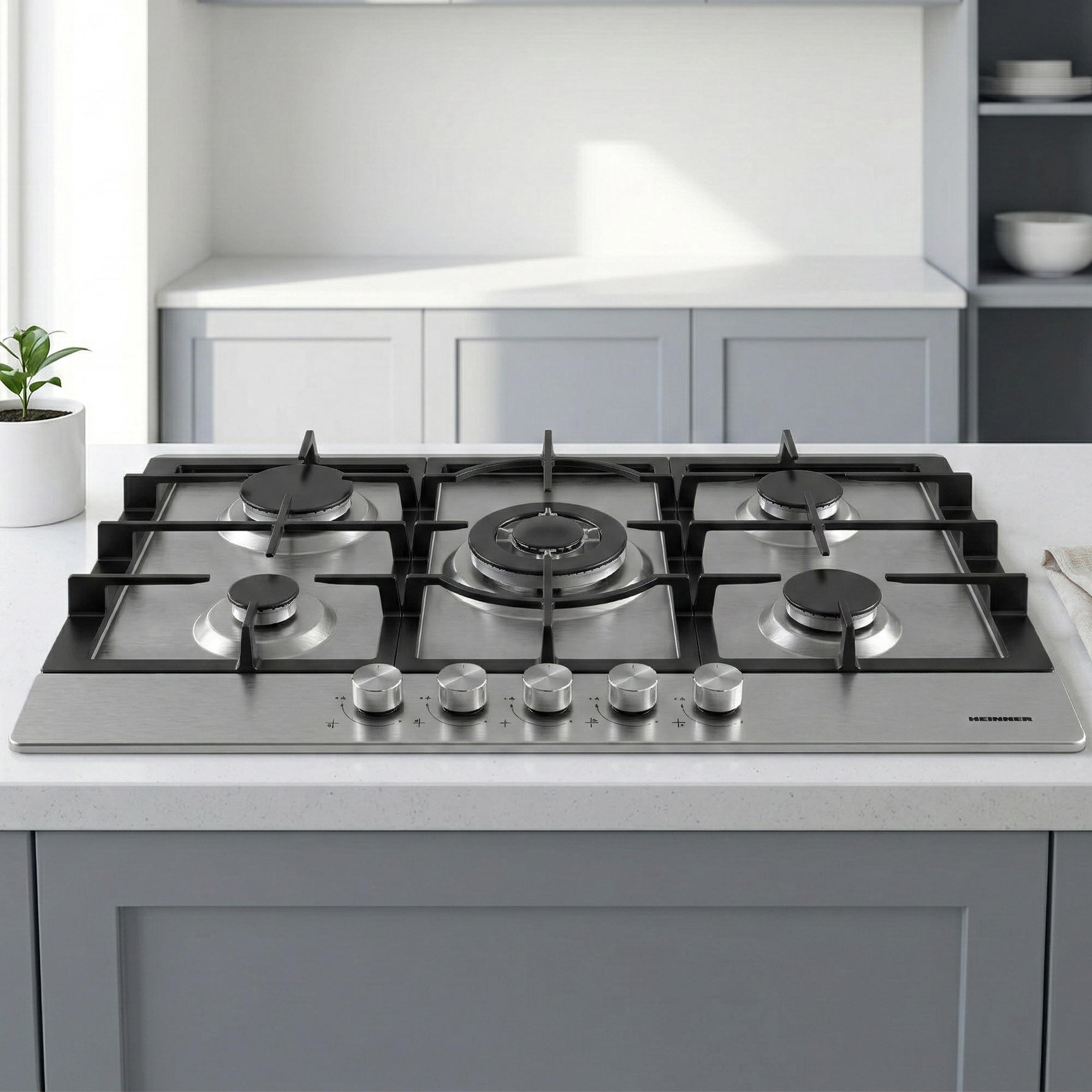 Stainless steel gas hob with five burners and silver knobs.