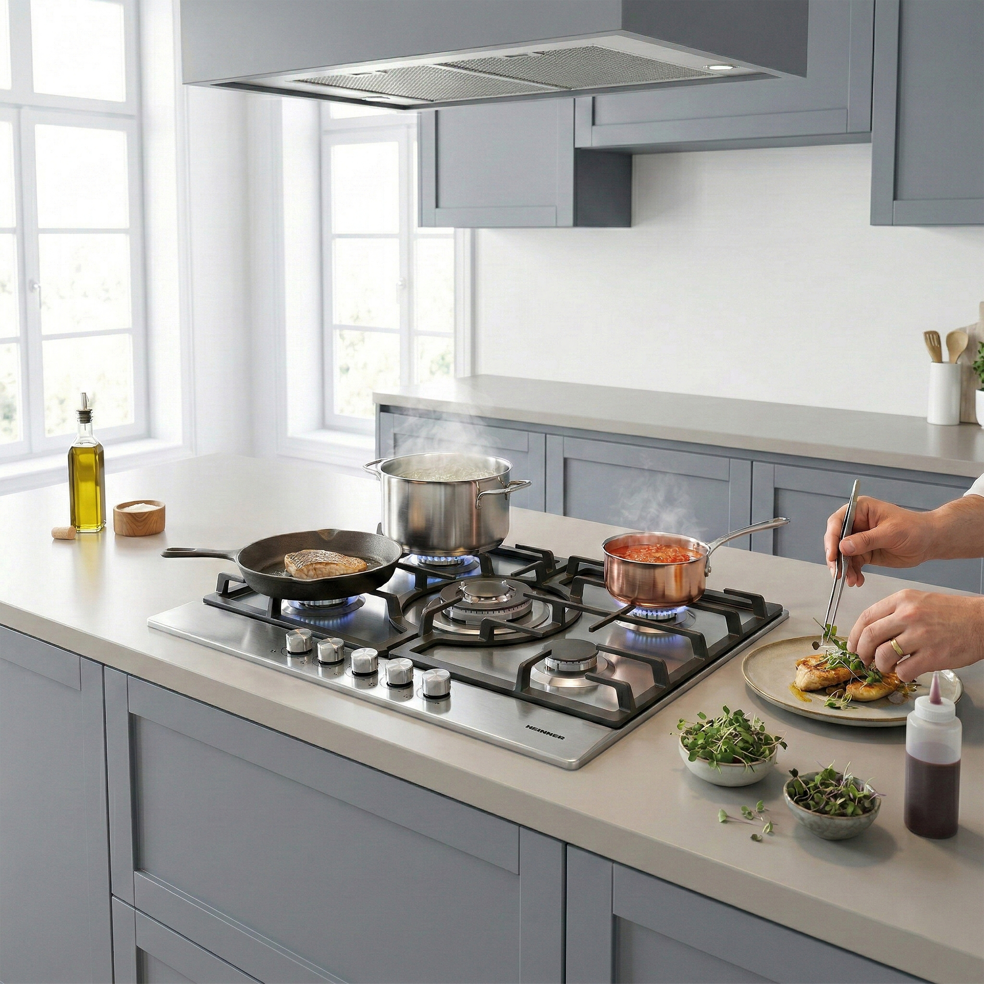 Kitchen: A cook garnishes a dish with tweezers, pots on the stove nearby.