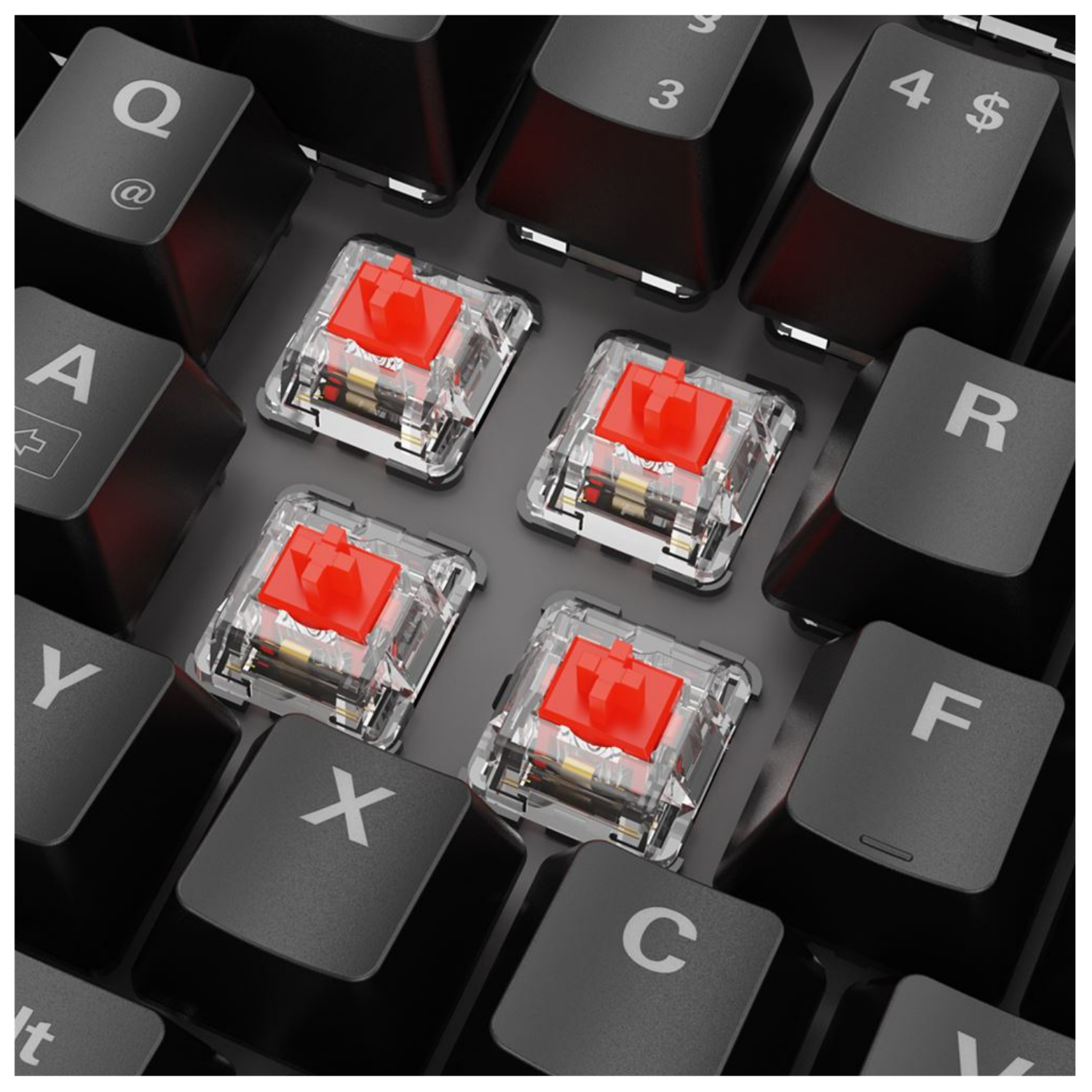 Four transparent key switches with red stems on a keyboard.