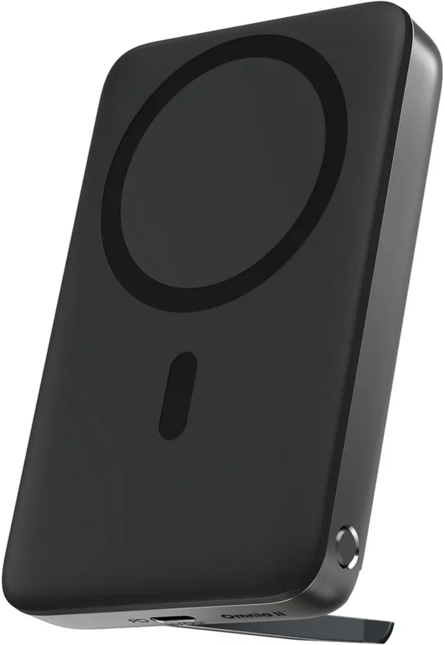 Un chargeur sans fil magnétique noir avec un design circulaire et un petit voyant lumineux.