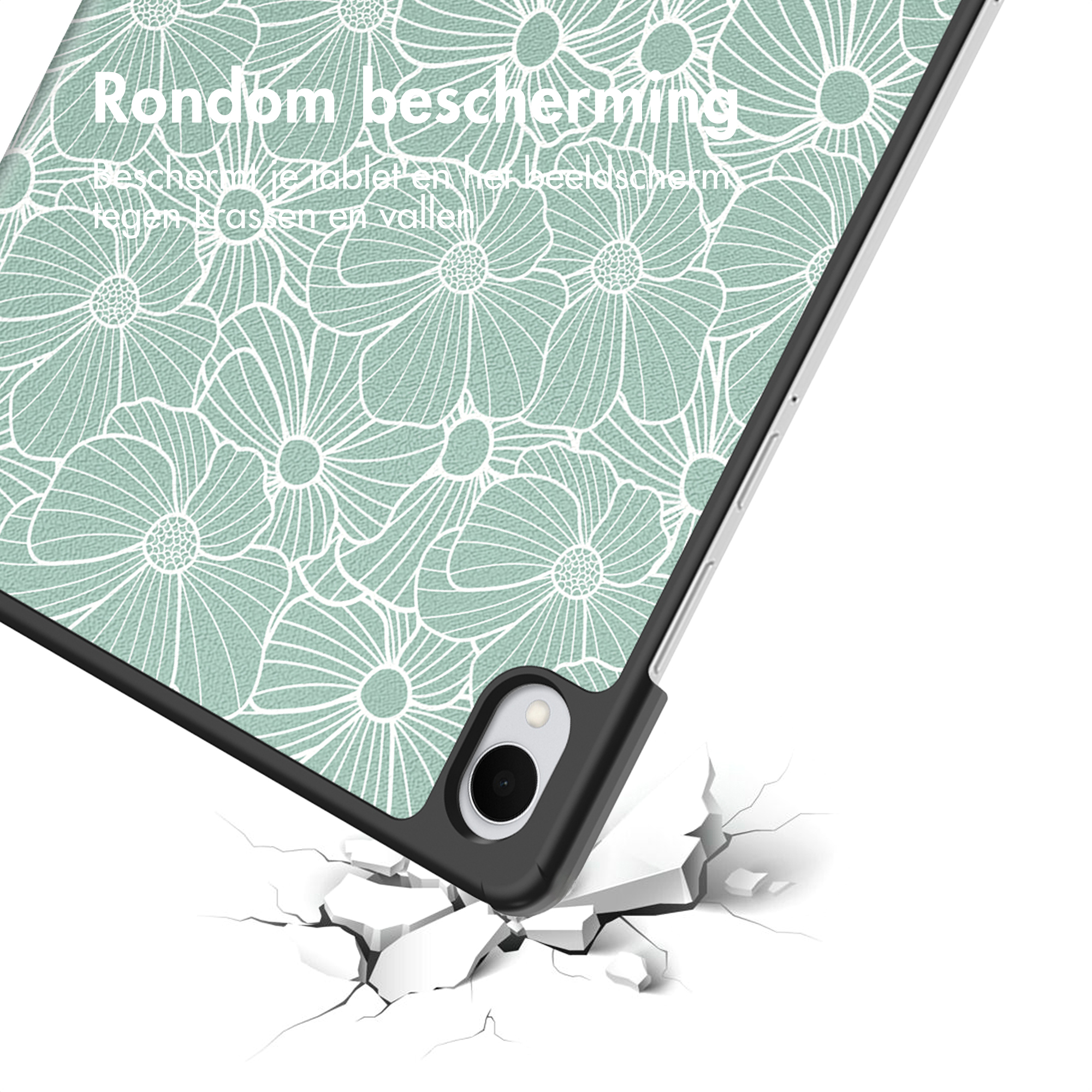 Groene tabletcase met bloemenpatroon valt op gebarsten ondergrond.