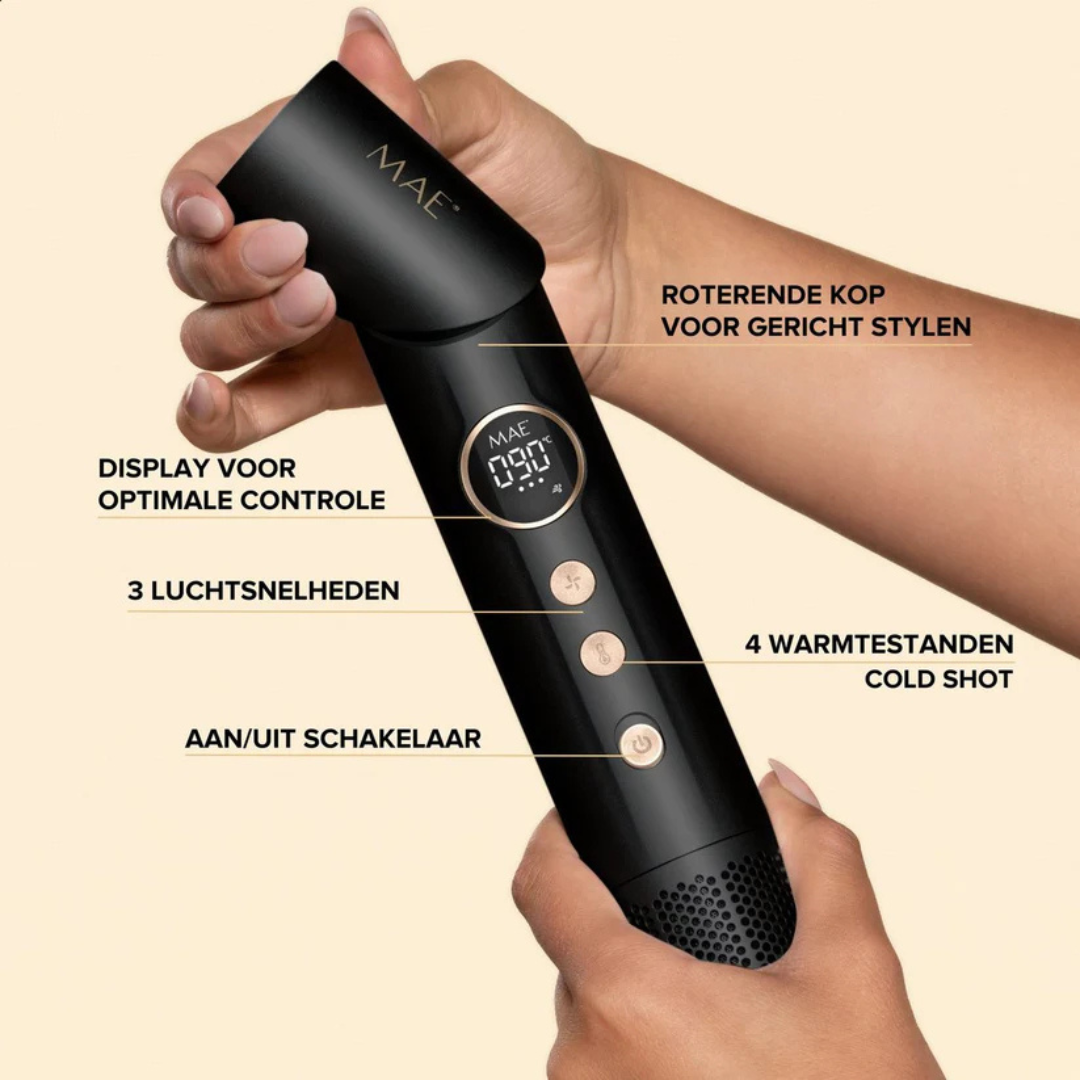 A hand holds a black hairdryer with digital controls and labels.