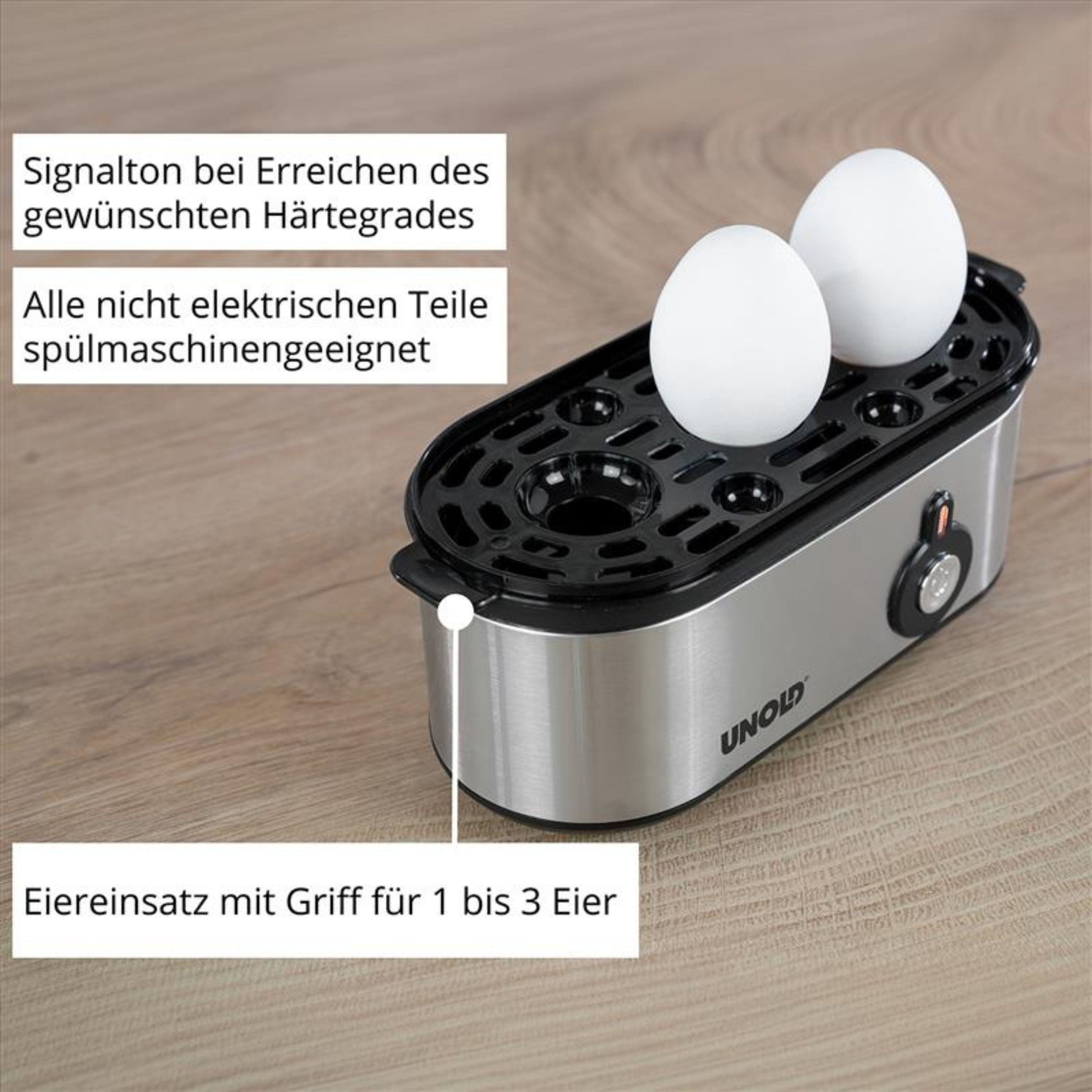 Srebrna maszynka do gotowania jajek z dwoma białymi jajkami na tacce.