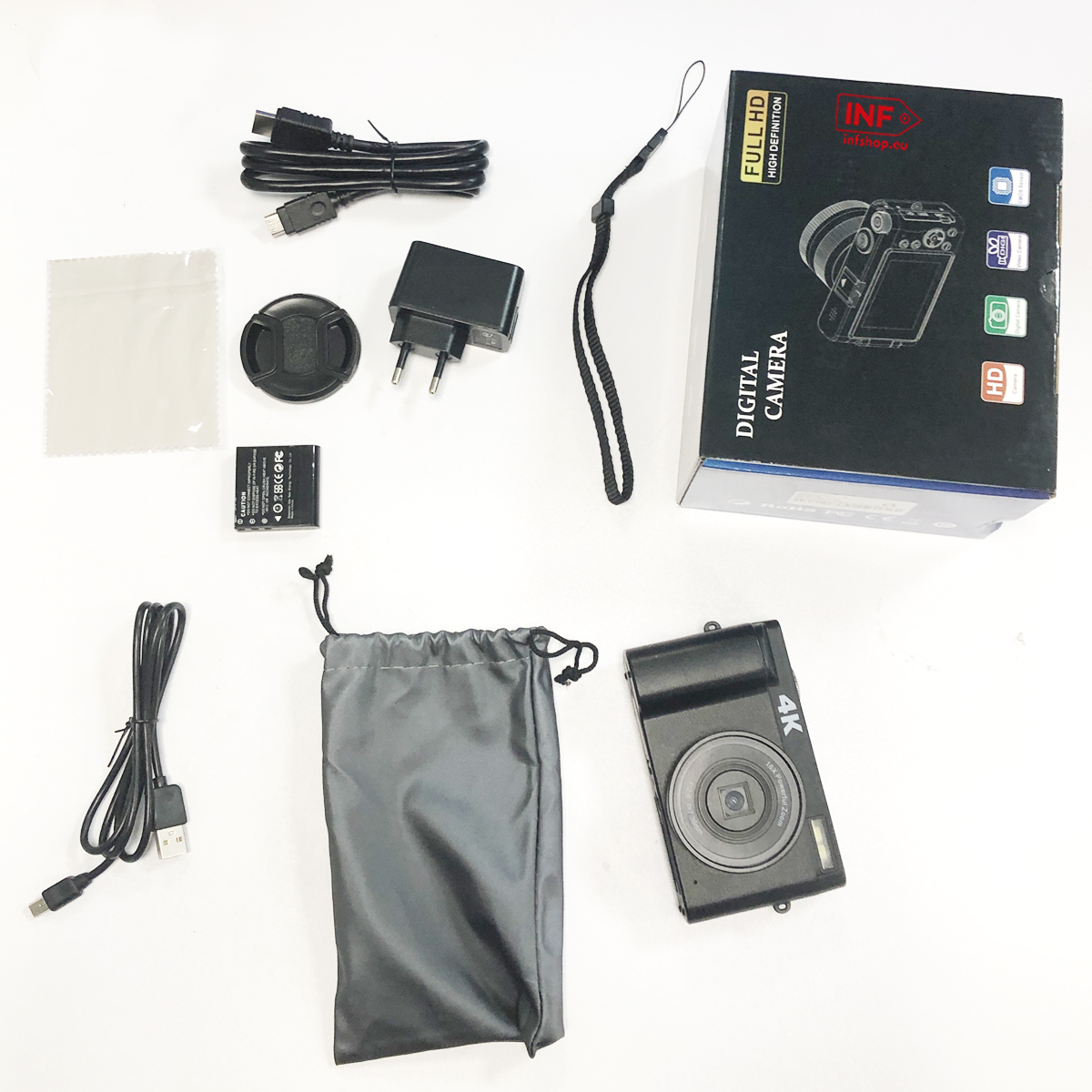 Akcesoria do aparatu cyfrowego: aparat, torba, bateria, ładowarka, kable i pudełko.