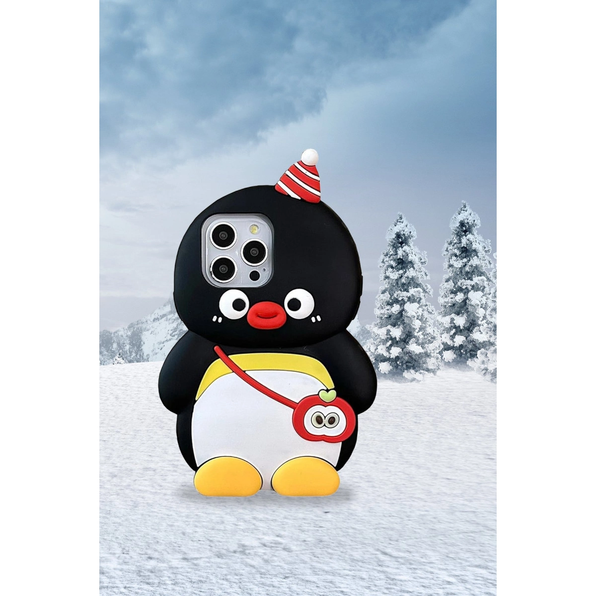 Karlı manzarada şapkalı ve elma çantalı penguen telefon kılıfı.