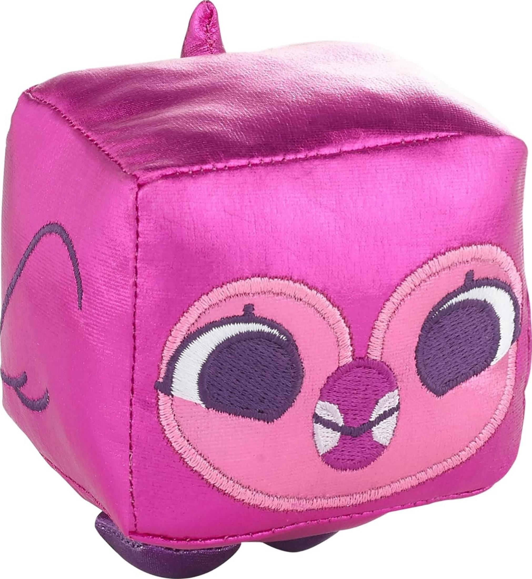 Ein glänzendes, pinkes Würfelspielzeug mit einem aufgestickten Eulen-Gesicht mit großen Augen.