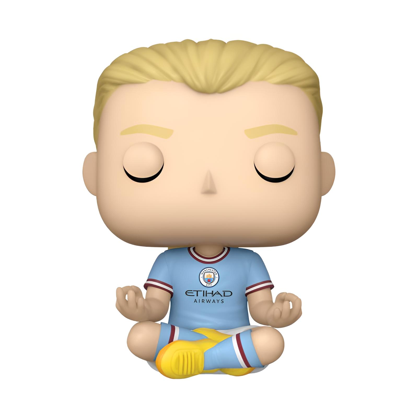 Ein Funko Pop von Erling Haaland in Manchester City Trikot in Meditationspose.