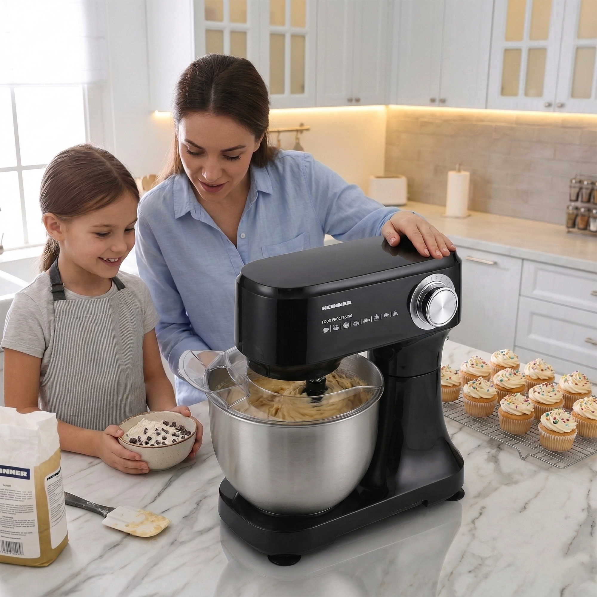 Mother and child bake together in a kitchen with a stand mixer and cupcakes.