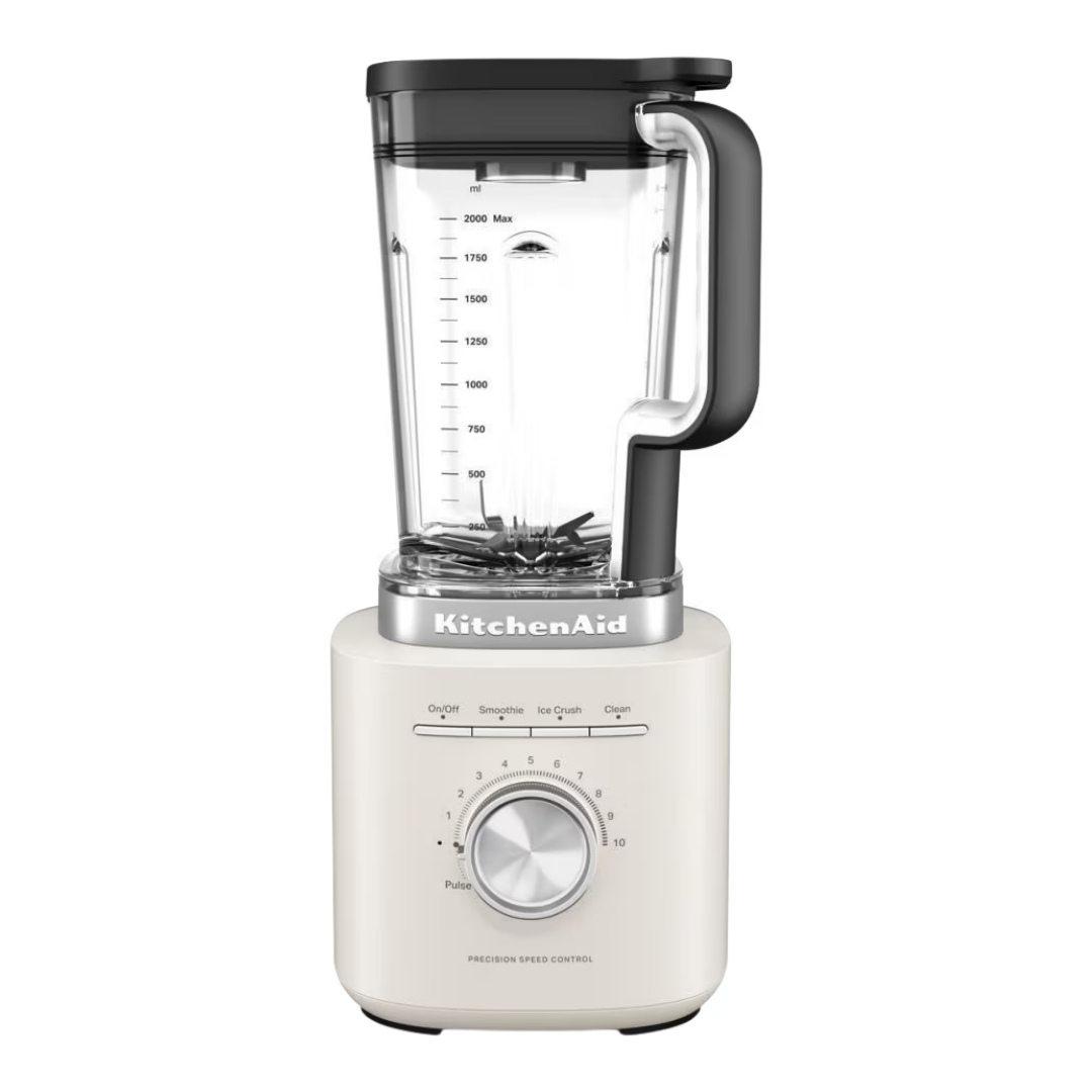 Siyah kapaklı ve kulplu krem rengi KitchenAid blender.