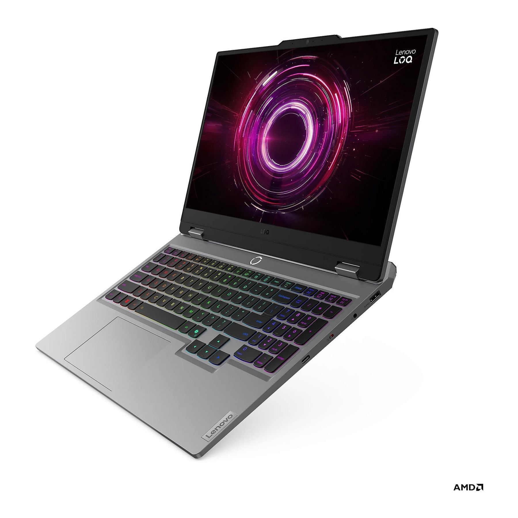 Un laptop argentato con tastiera retroilluminata e design circolare sullo schermo.