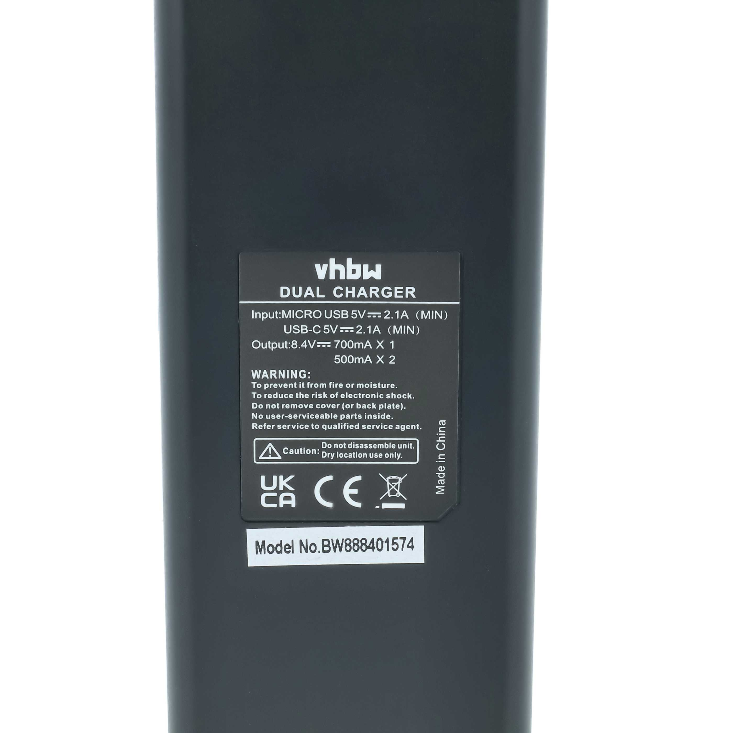 Ein schwarzes Dual-Ladegerät mit Beschriftungen: vhbw, DUAL CHARGER, Eingabe, Ausgabe und Warnhinweise.