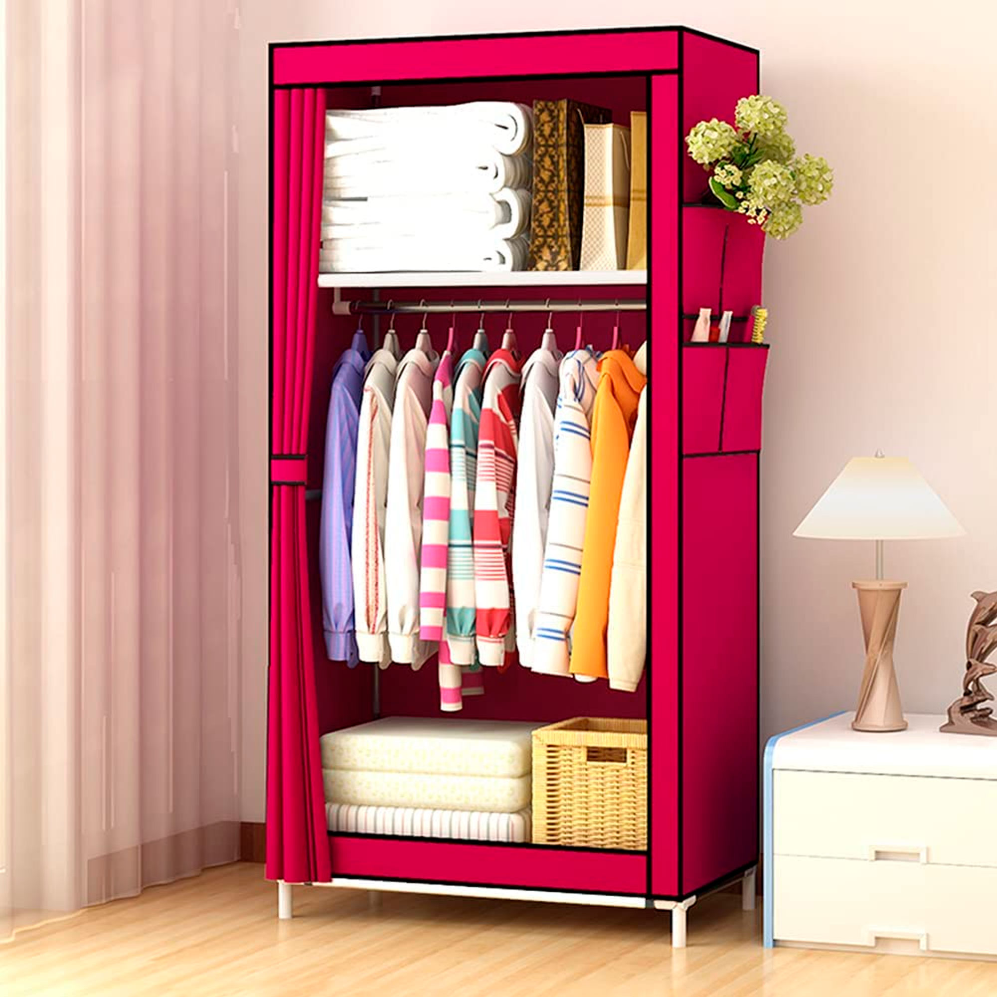 Un armario de tela rosa con ropa, libros y decoración.