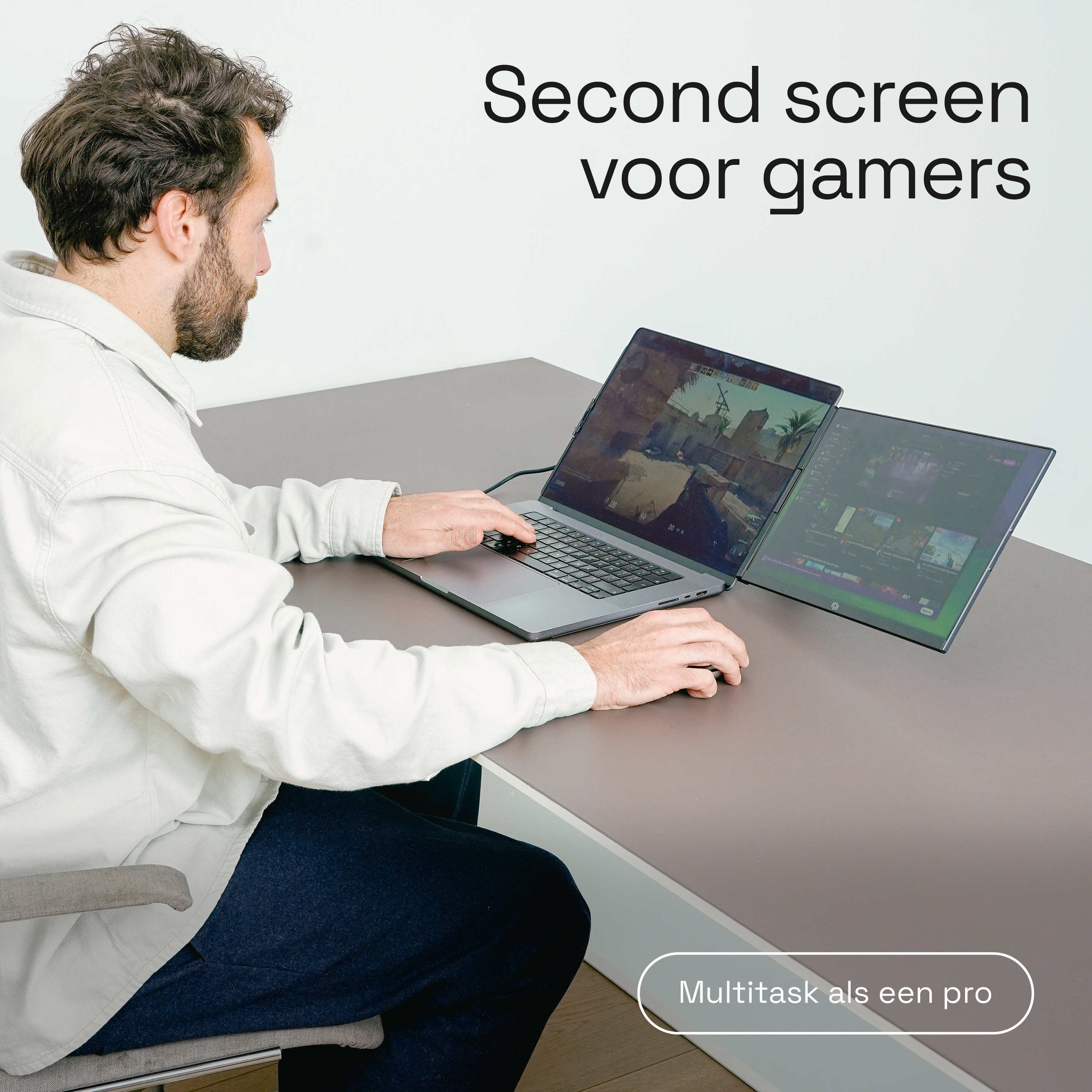 Man speelt computerspel op twee schermen. Tekst: Second screen voor gamers