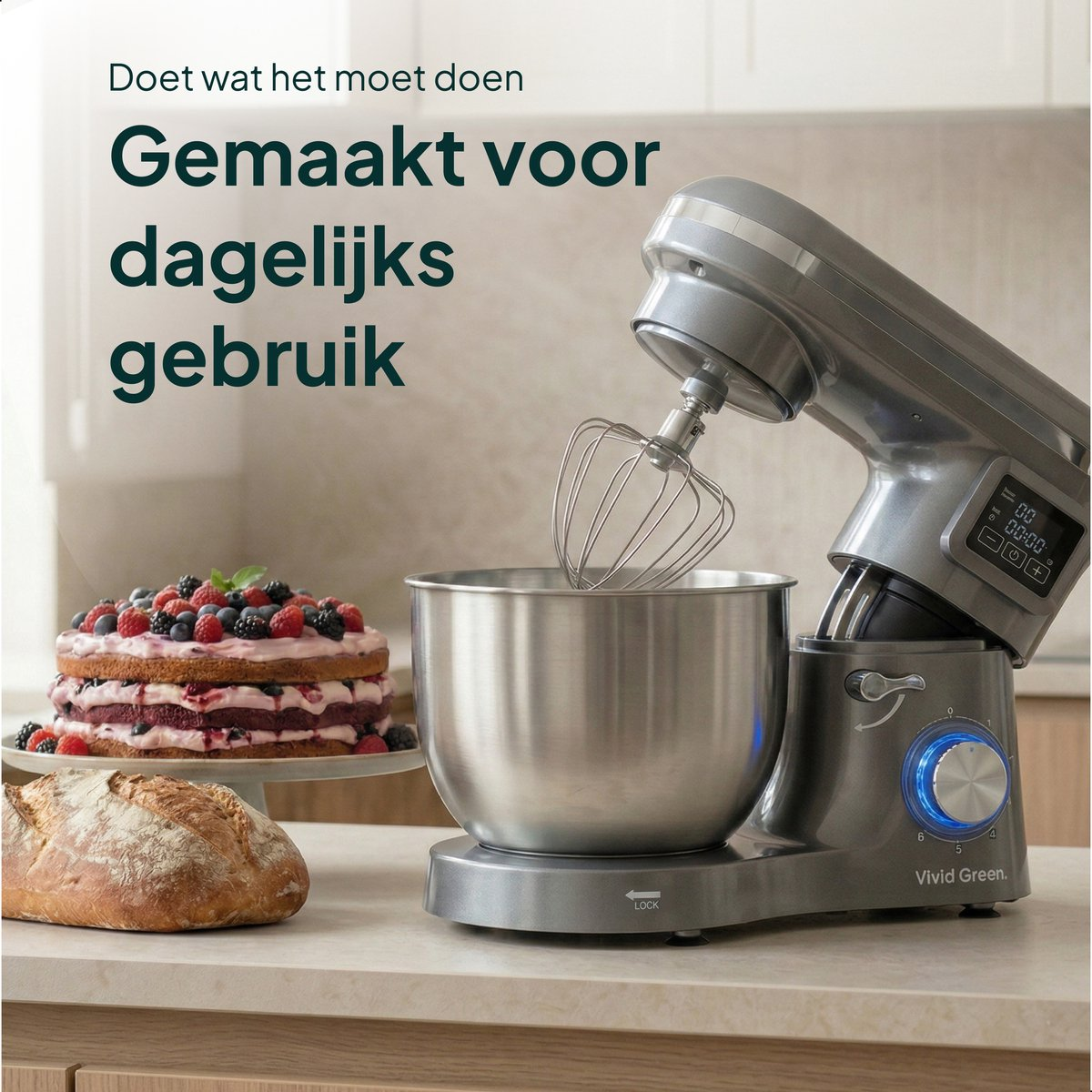 A silver stand mixer with a bowl, cake, and bread on a kitchen counter.